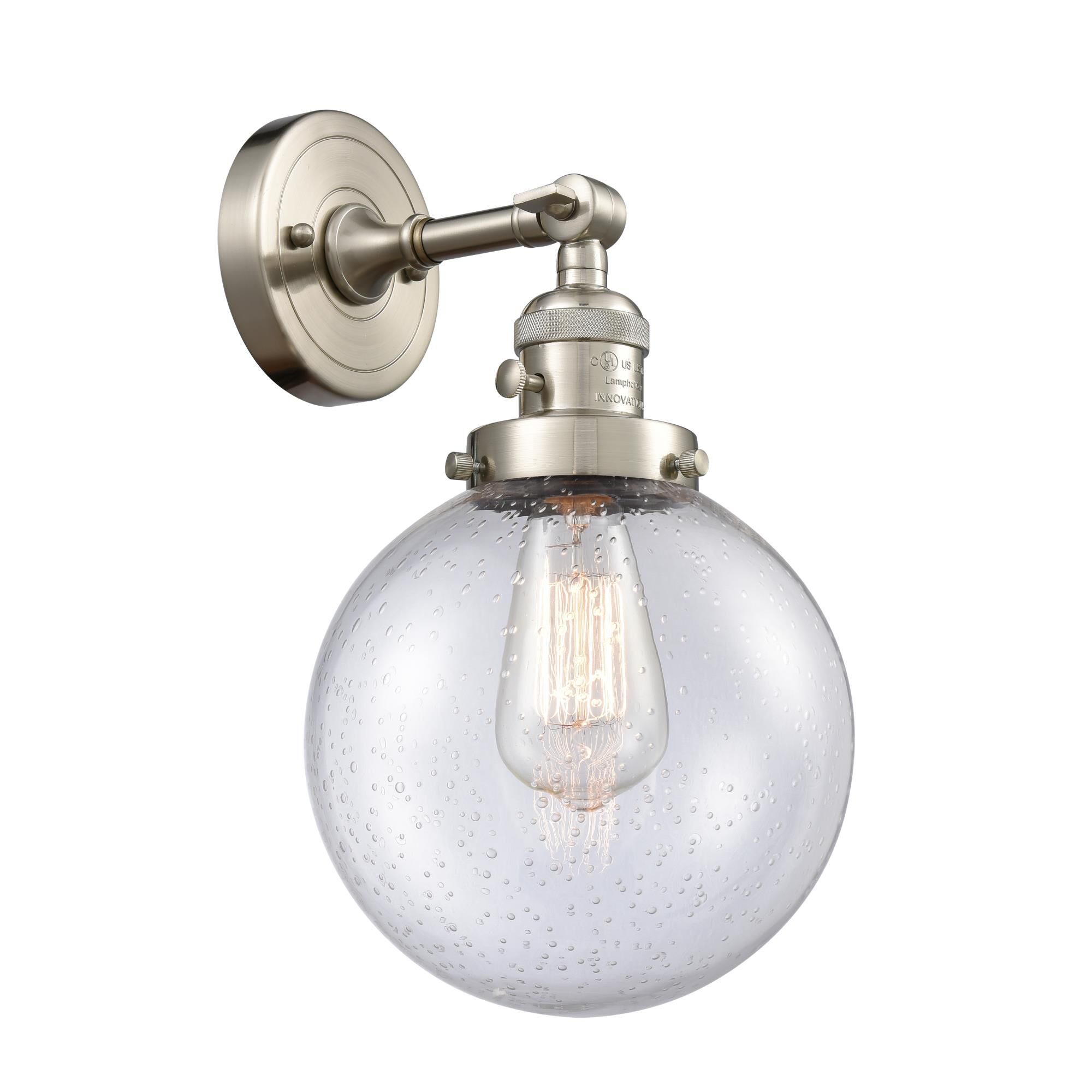 Shown in Brushed Satin Nickel finish and Seedy glass and Switch on Socket accent