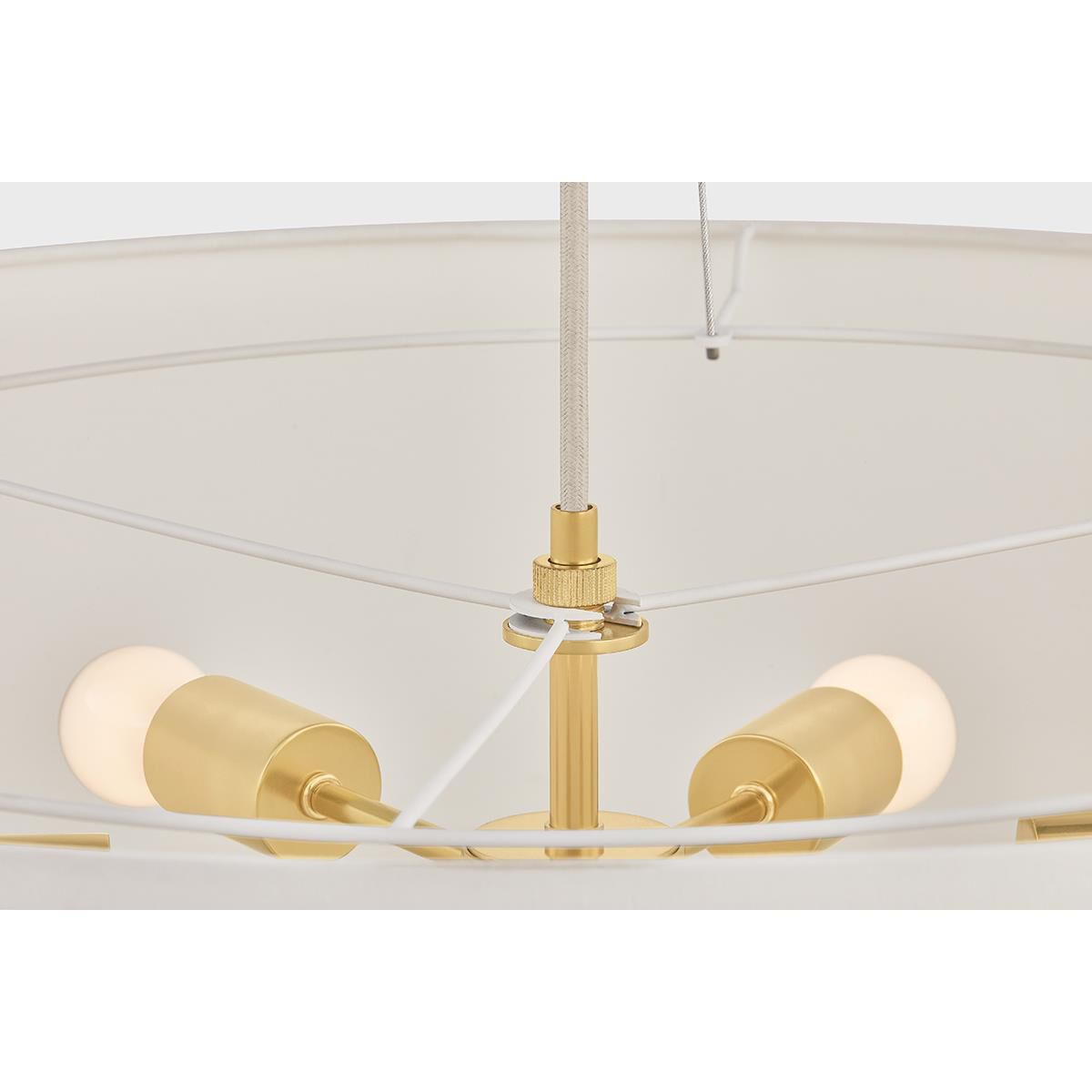 Shown in Aged Brass finish and White Linen shade