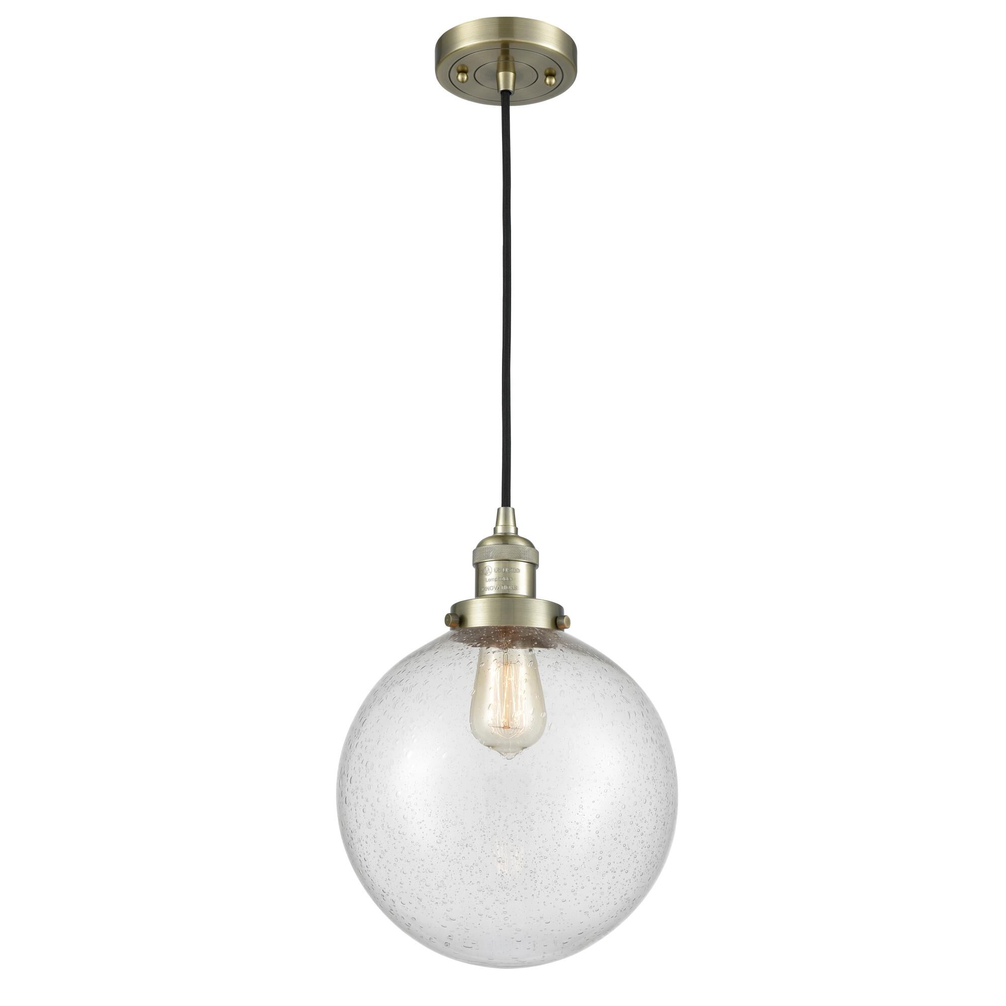 Shown in Antique Brass finish and Seedy glass