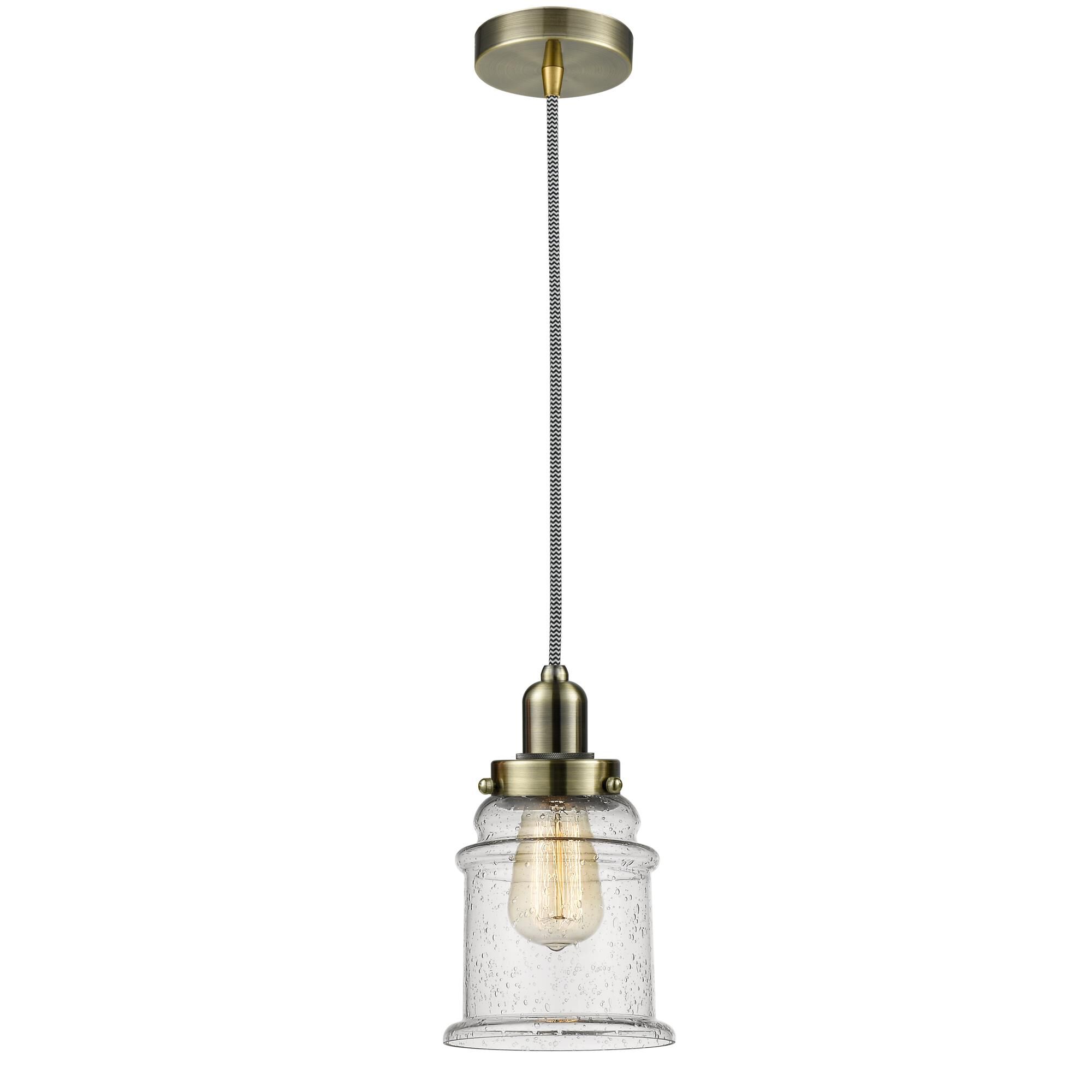 Shown in Antique Brass finish and Bell glass and Glass shade and Antique Brass Whitney Socket Cover accent