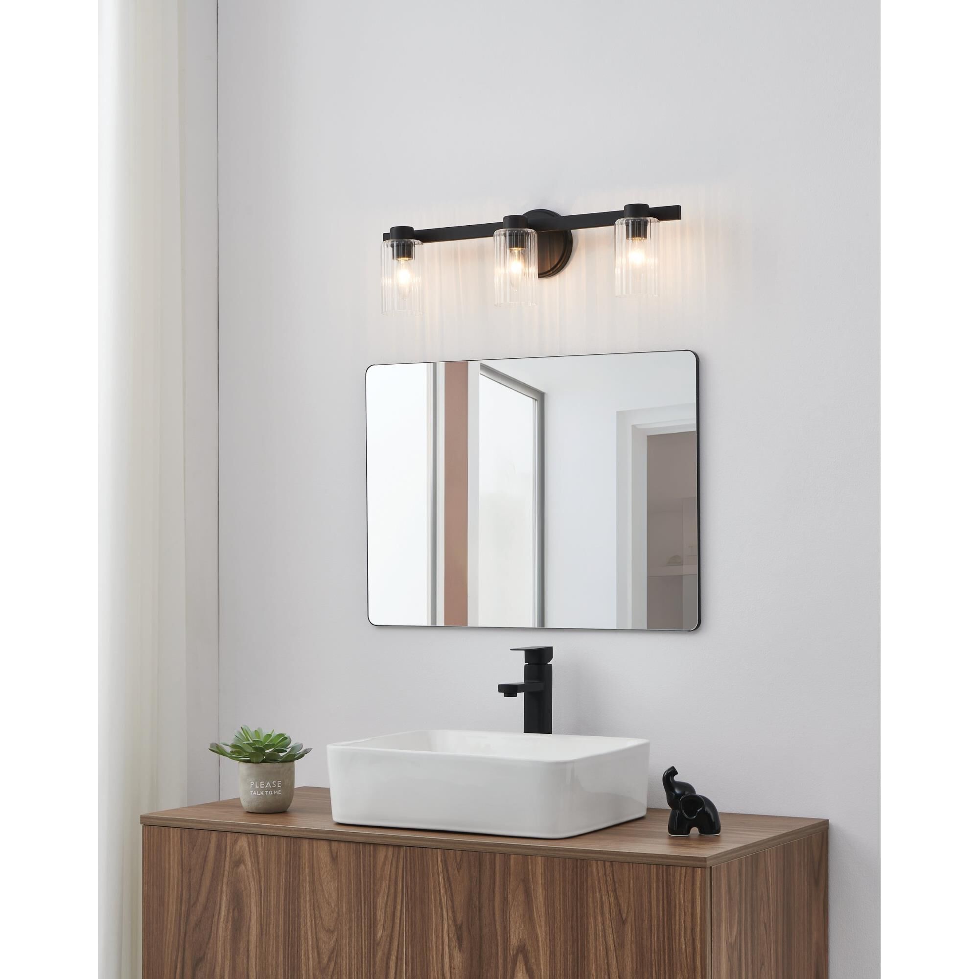 Shown in Matte Black finish and Clear Ribbed glass