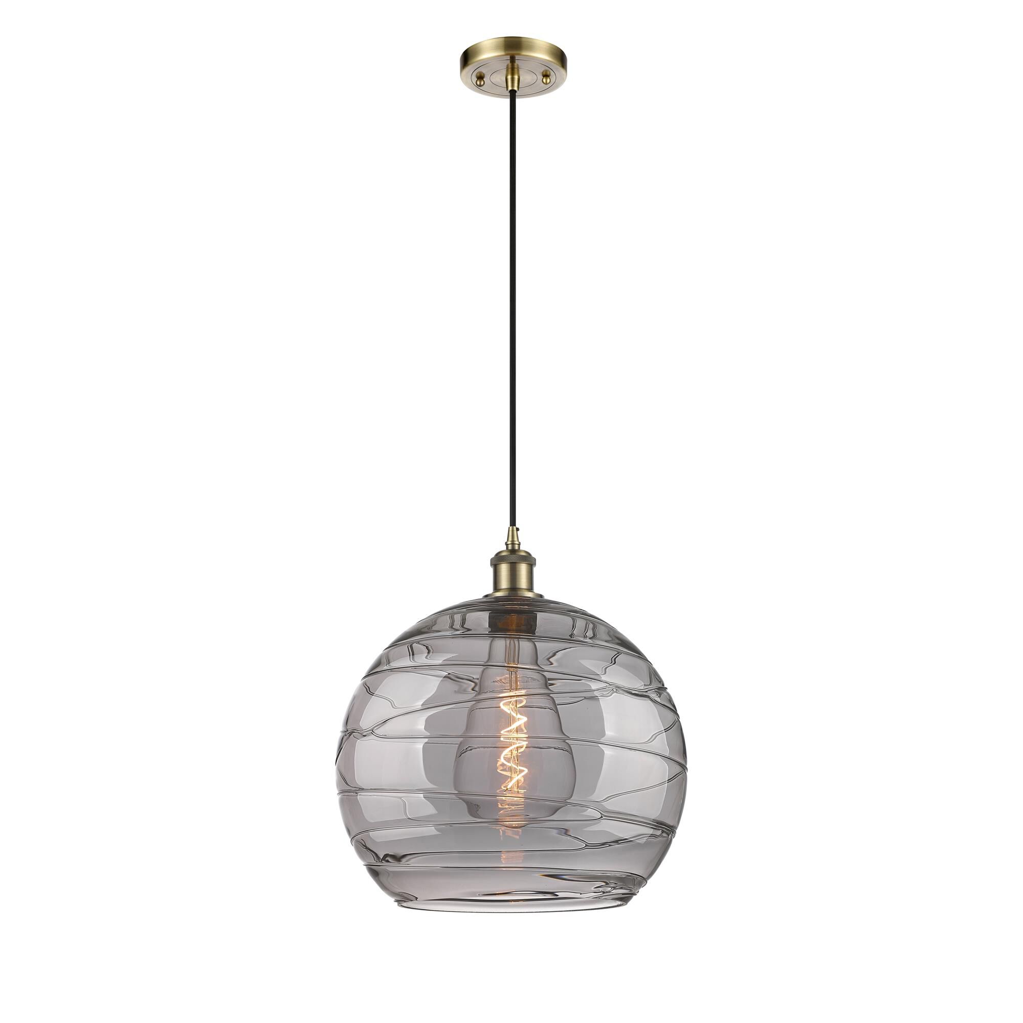 Shown in Antique Brass finish and Light Smoke Deco Swirl glass