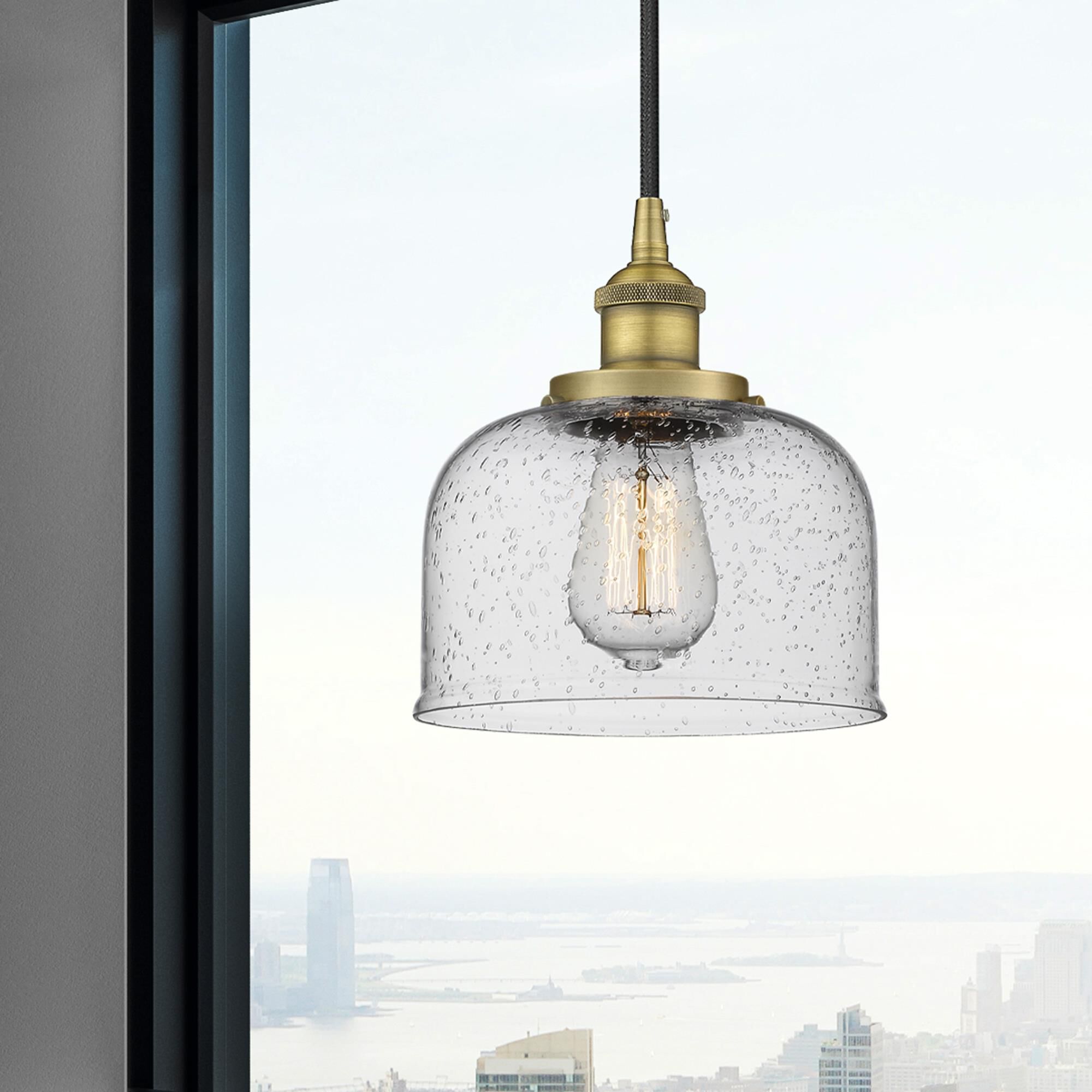 Shown in Brushed Brass finish and Seedy glass