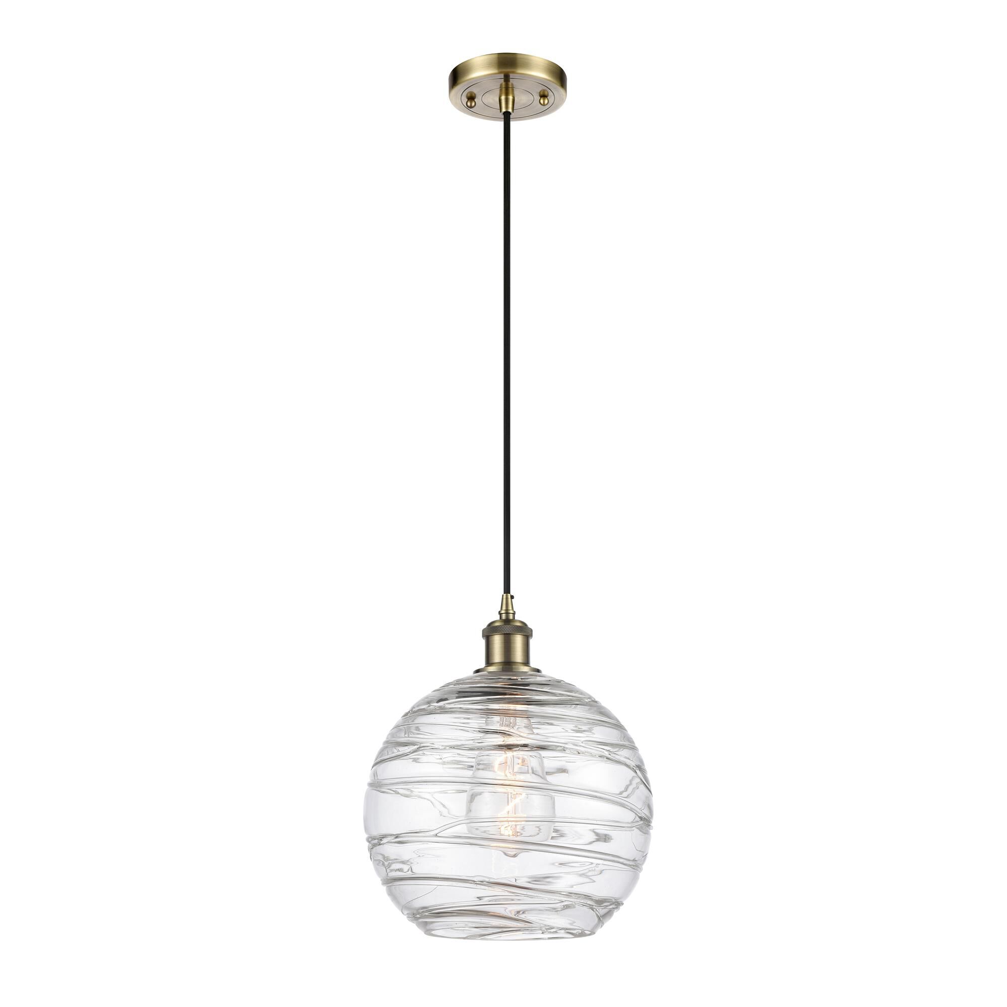 Shown in Antique Brass finish and Clear Deco Swirl glass