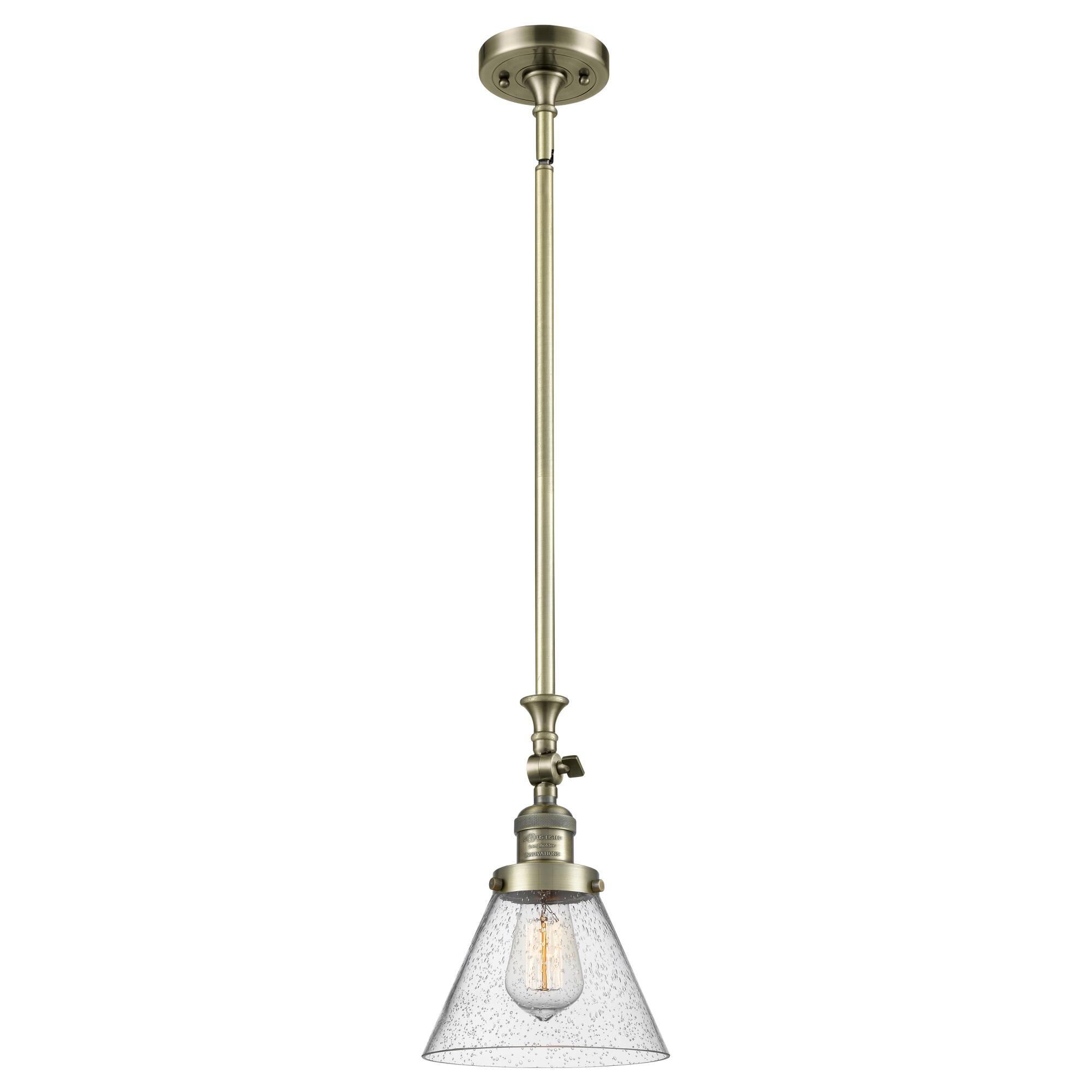 Shown in Antique Brass finish and Seedy glass