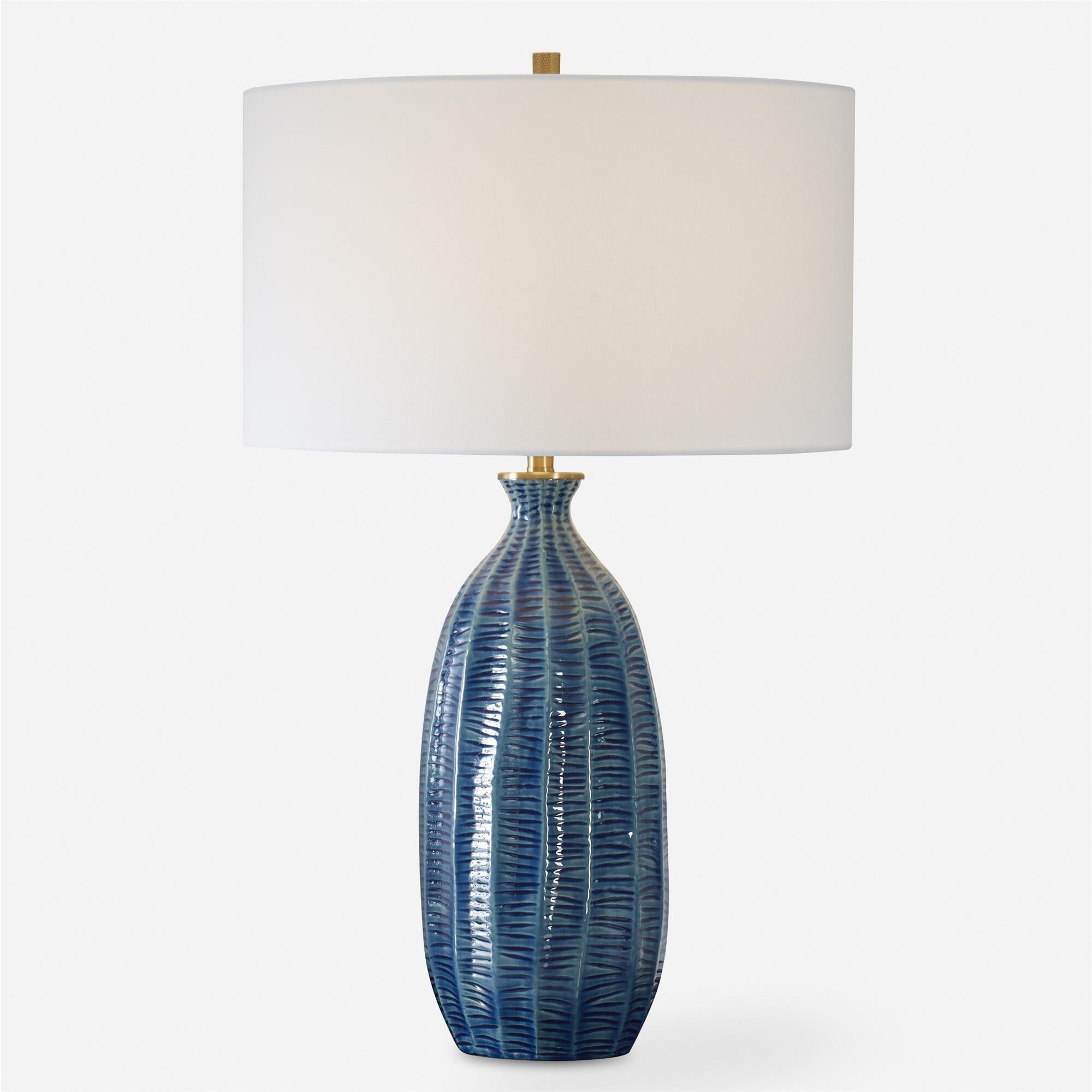 Shown in Where Coastal Charm Meets Refined Elegance, Featuring A Heavily Textured Ceramic Base In A Rich Blue finish and Drum With Liner shade