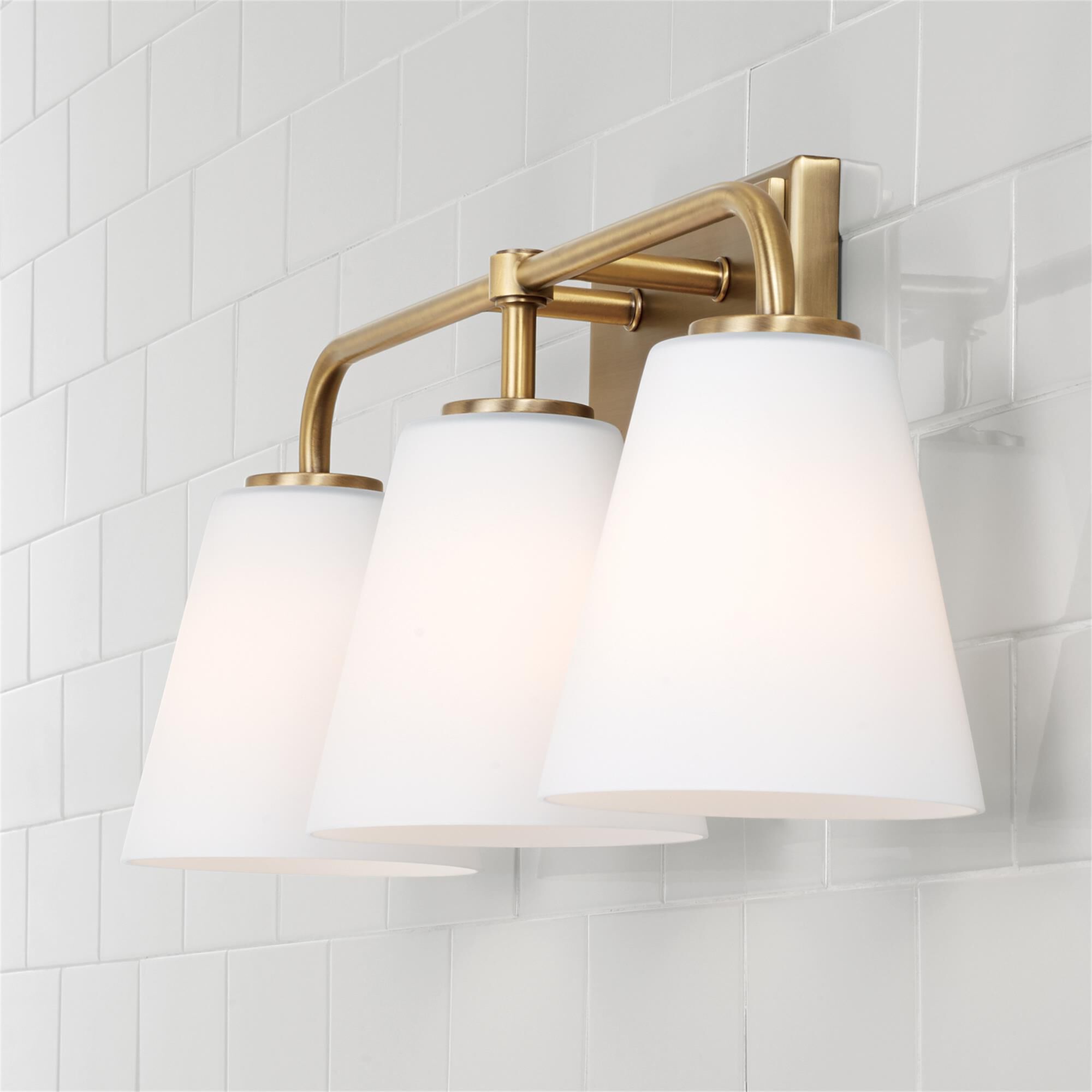Shown in Aged Brass finish and Soft White glass