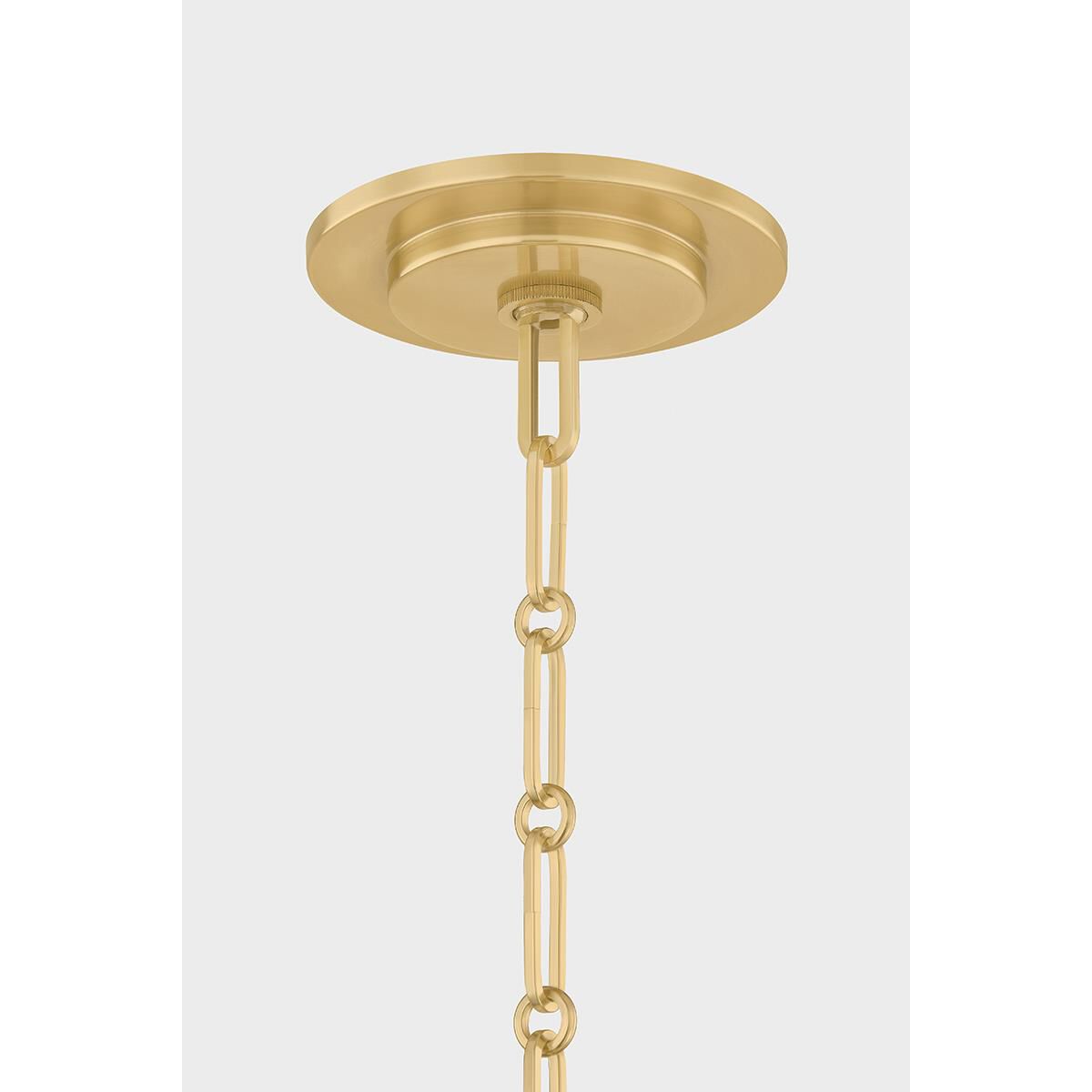 Shown in Aged Brass and Soft White finish and White glass