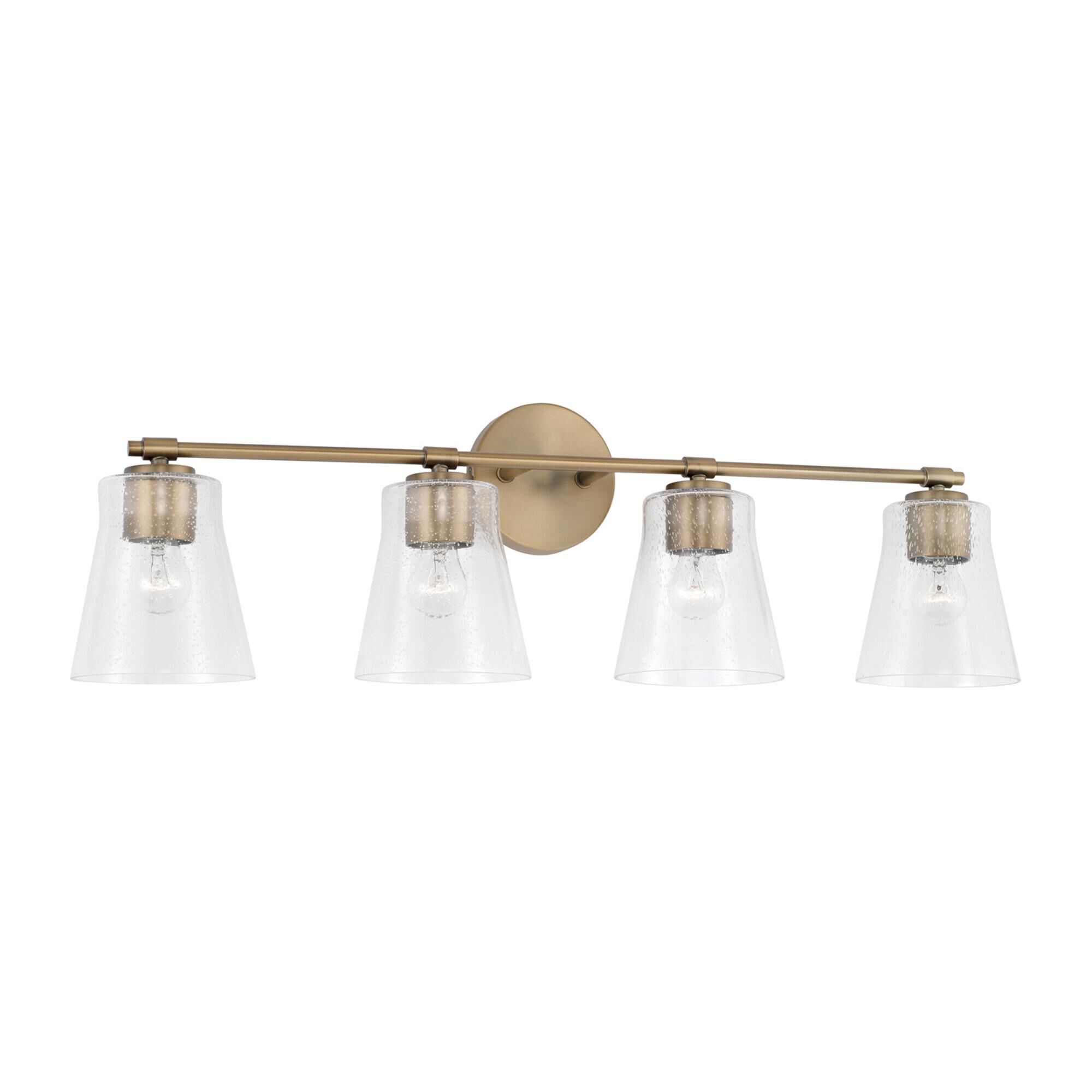 Shown in Aged Brass finish and Clear Seeded glass