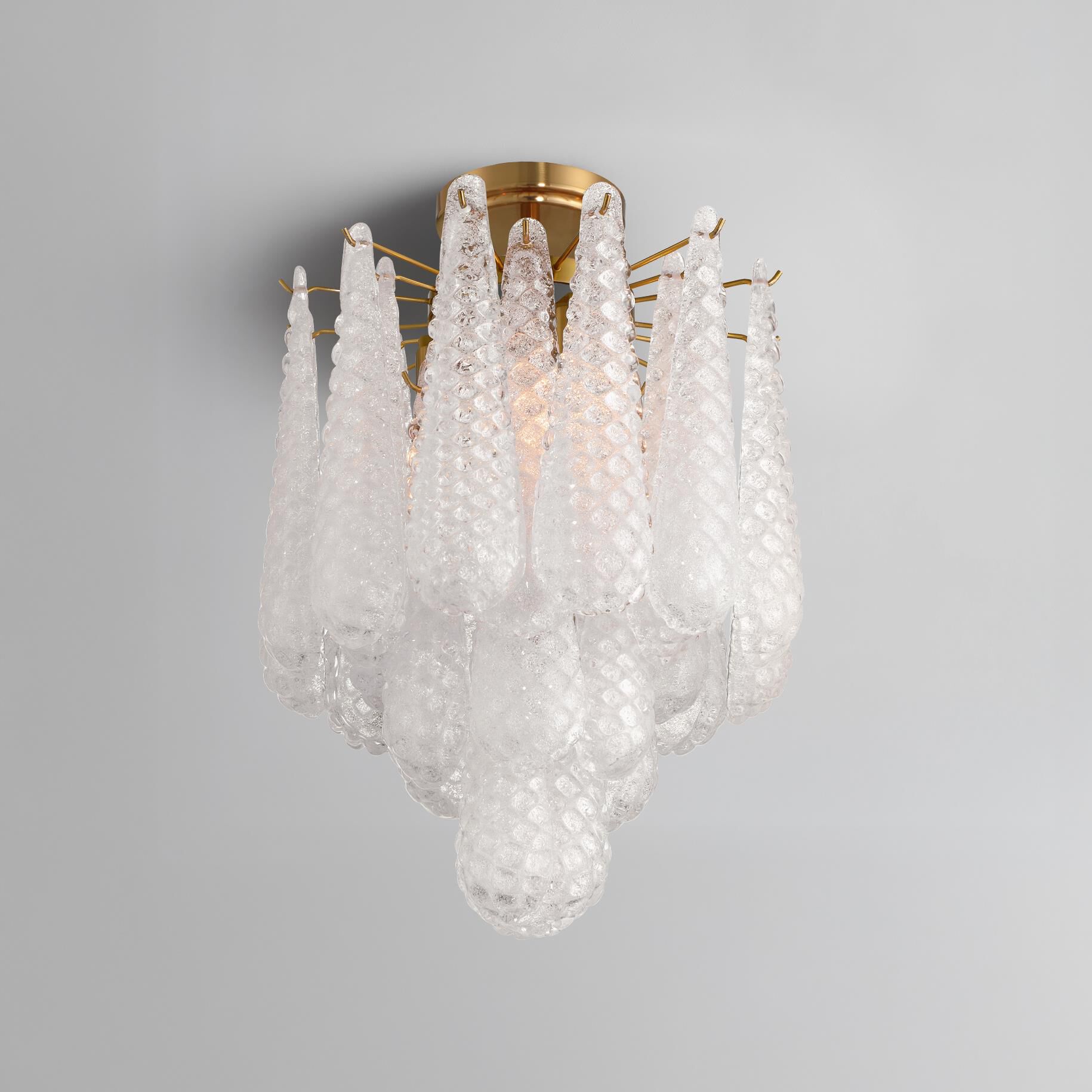 Shown in Aged Brass finish and Sand Clear glass