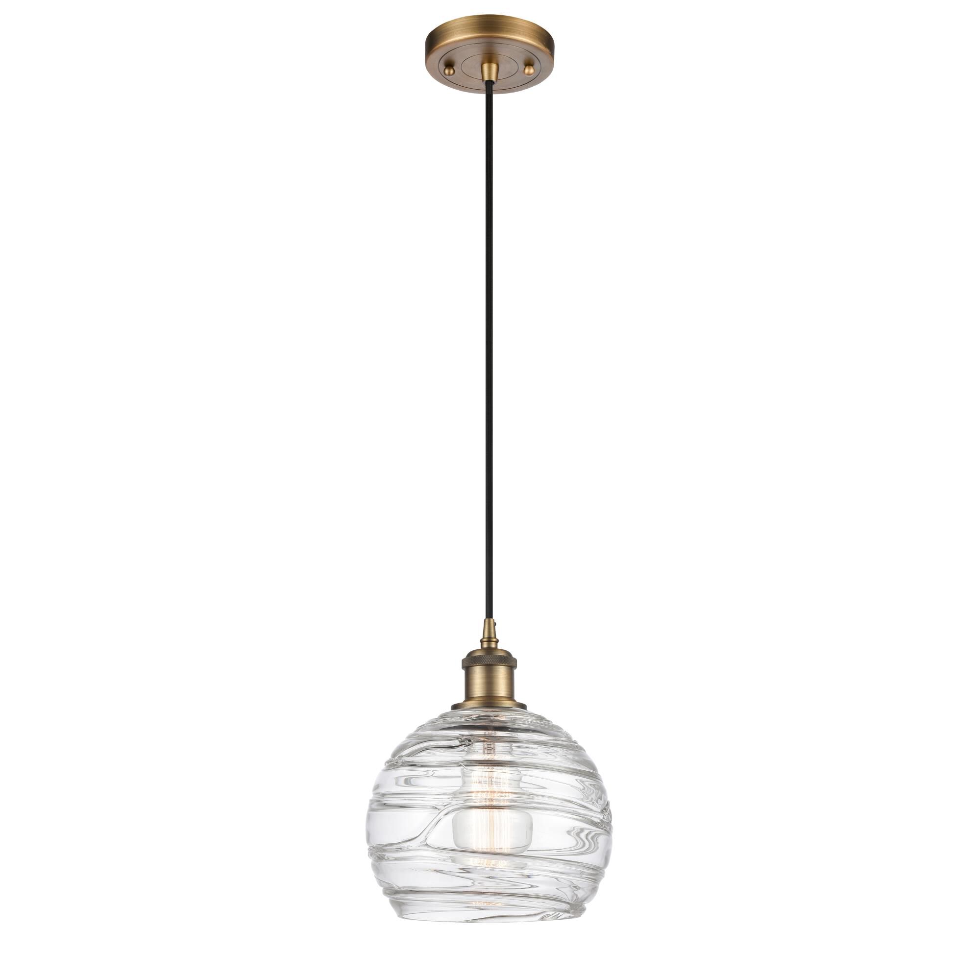 Shown in Brushed Brass finish and Clear Deco Swirl glass