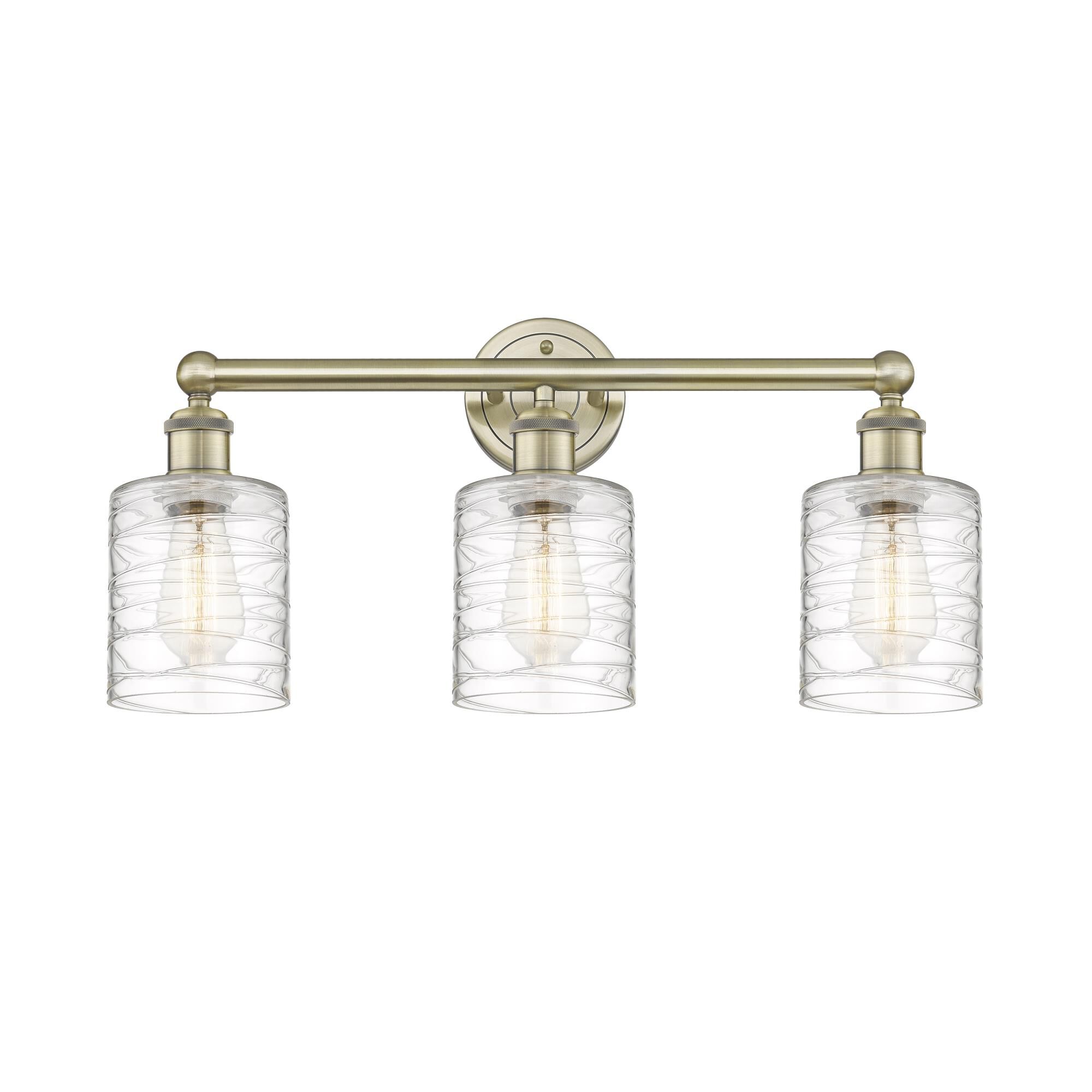 Shown in Antique Brass finish and Deco Swirl glass