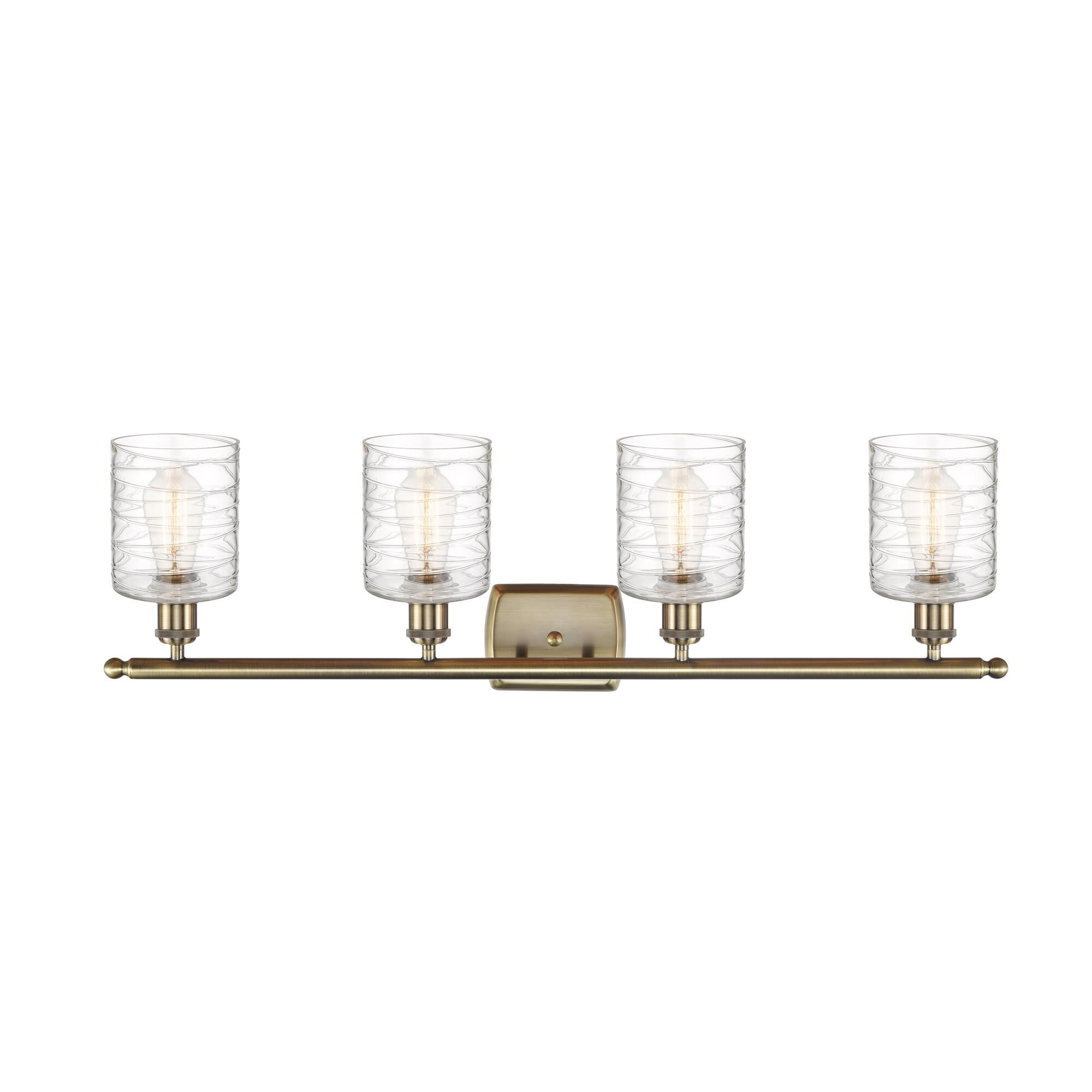 Shown in Antique Brass finish and Deco Swirl glass