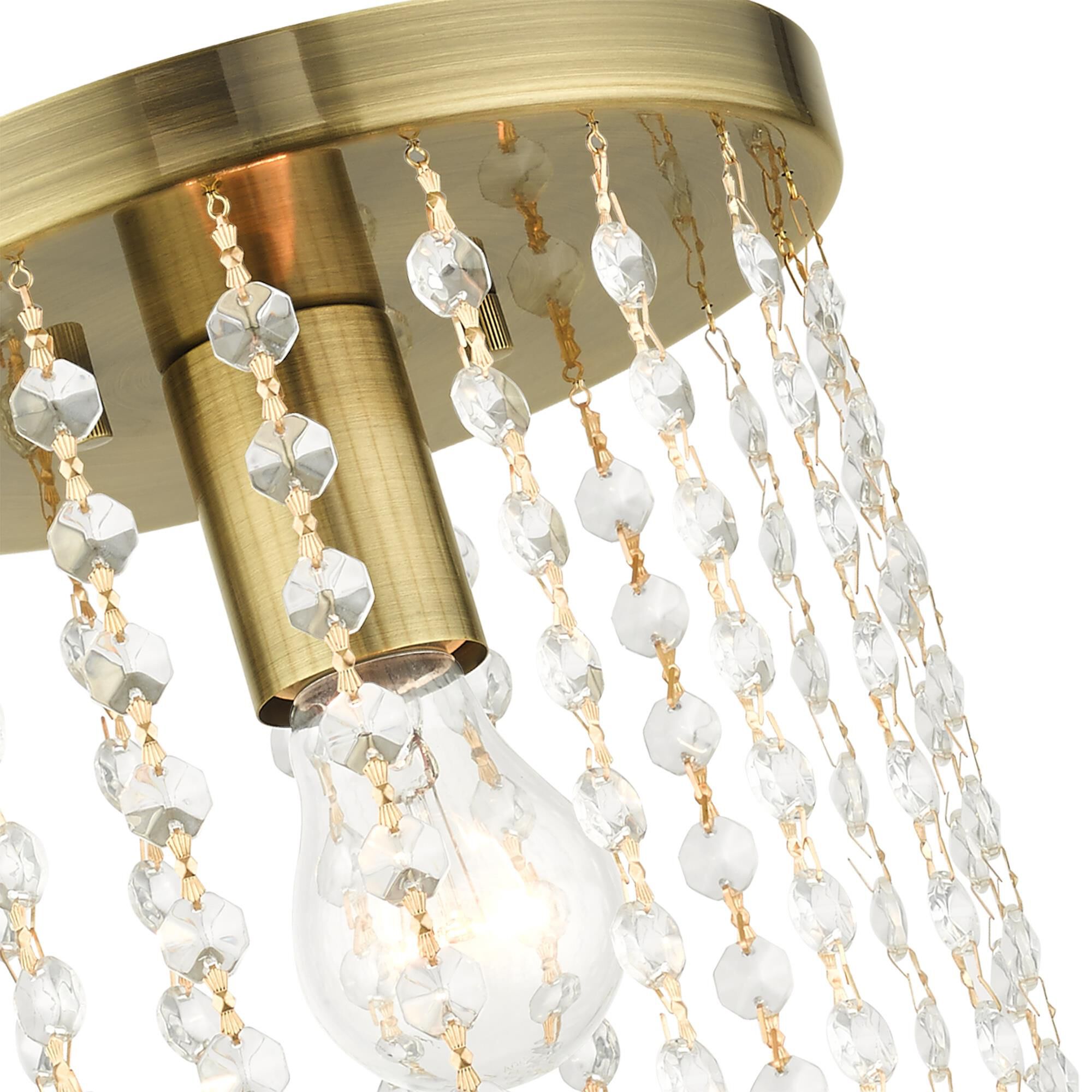 Shown in Antique Brass finish and Hand Assembled Crystal Shade glass