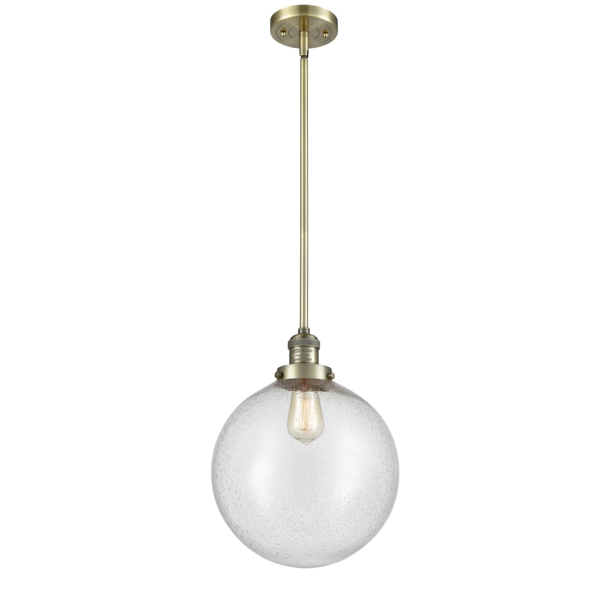 Shown in Antique Brass finish and Seedy Beacon glass