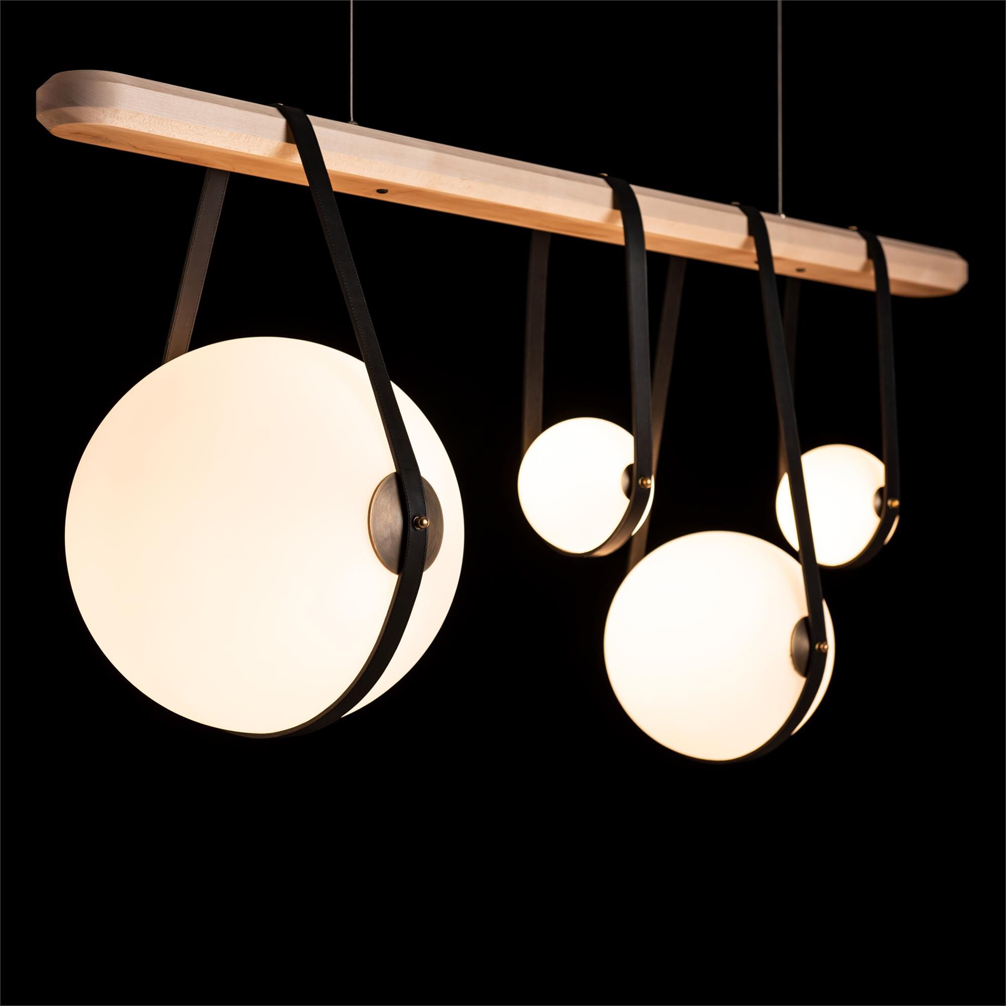 Shown in Black finish and Opal glass and Antique Brass accent