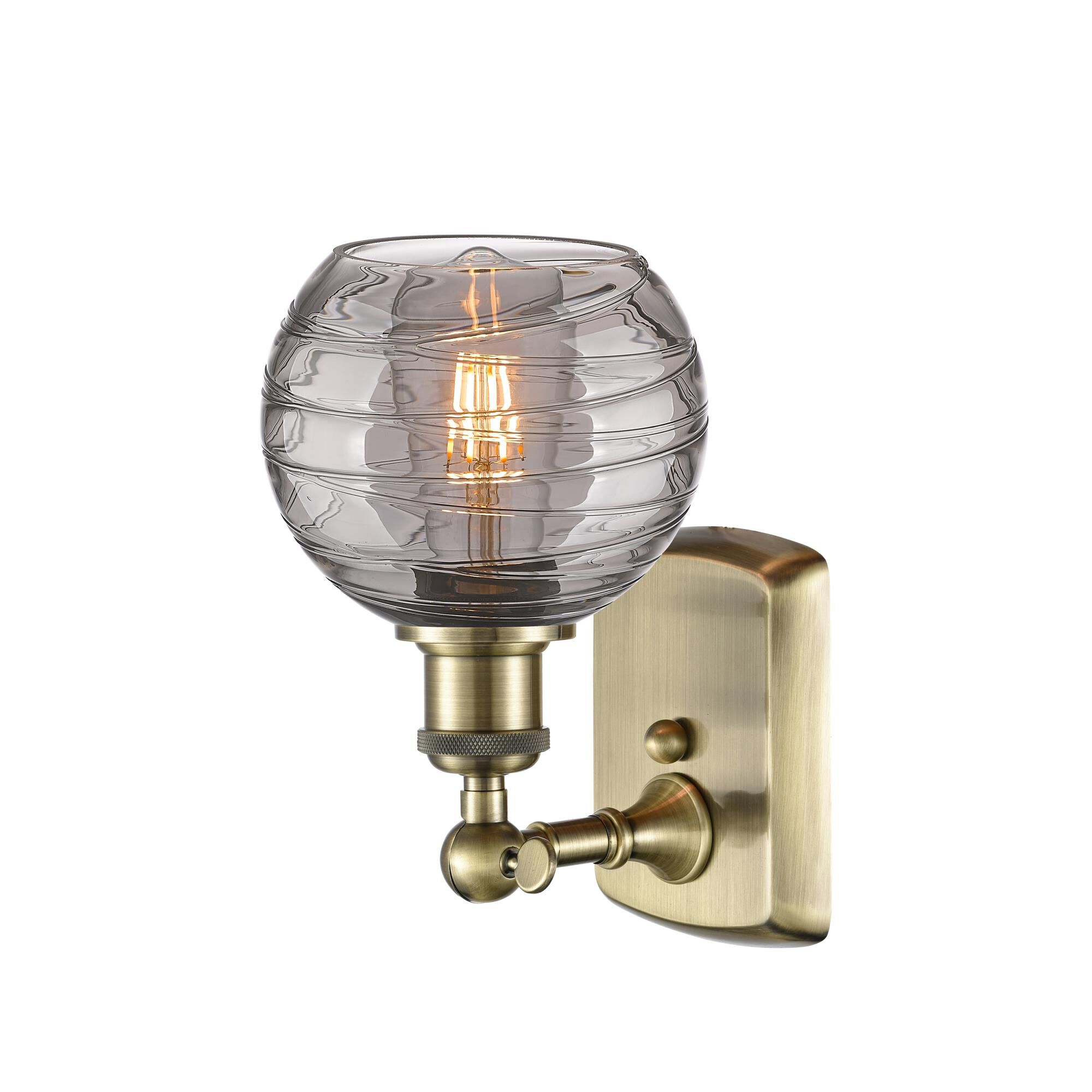 Shown in Antique Brass finish and Light Smoke Deco Swirl glass