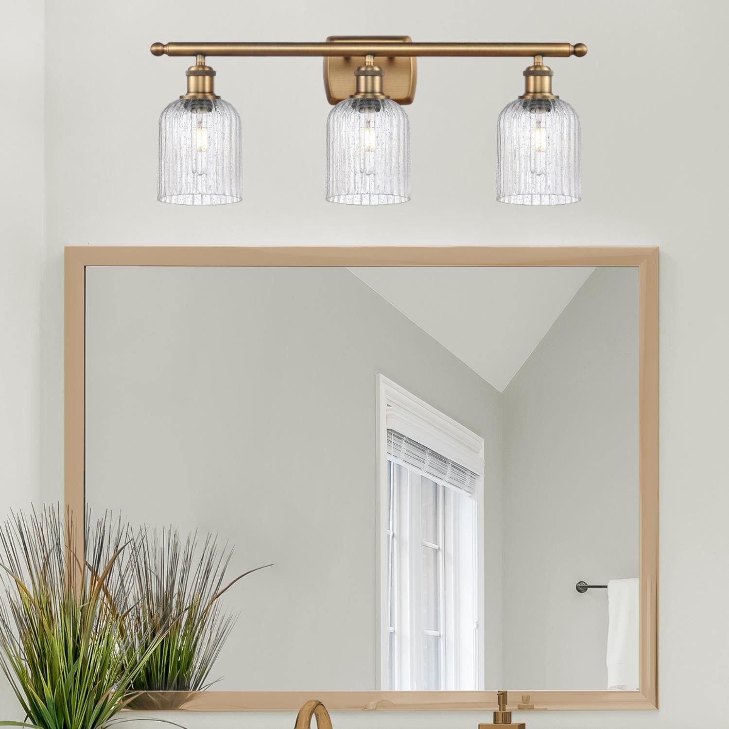 Shown in Brushed Brass finish and Seedy glass