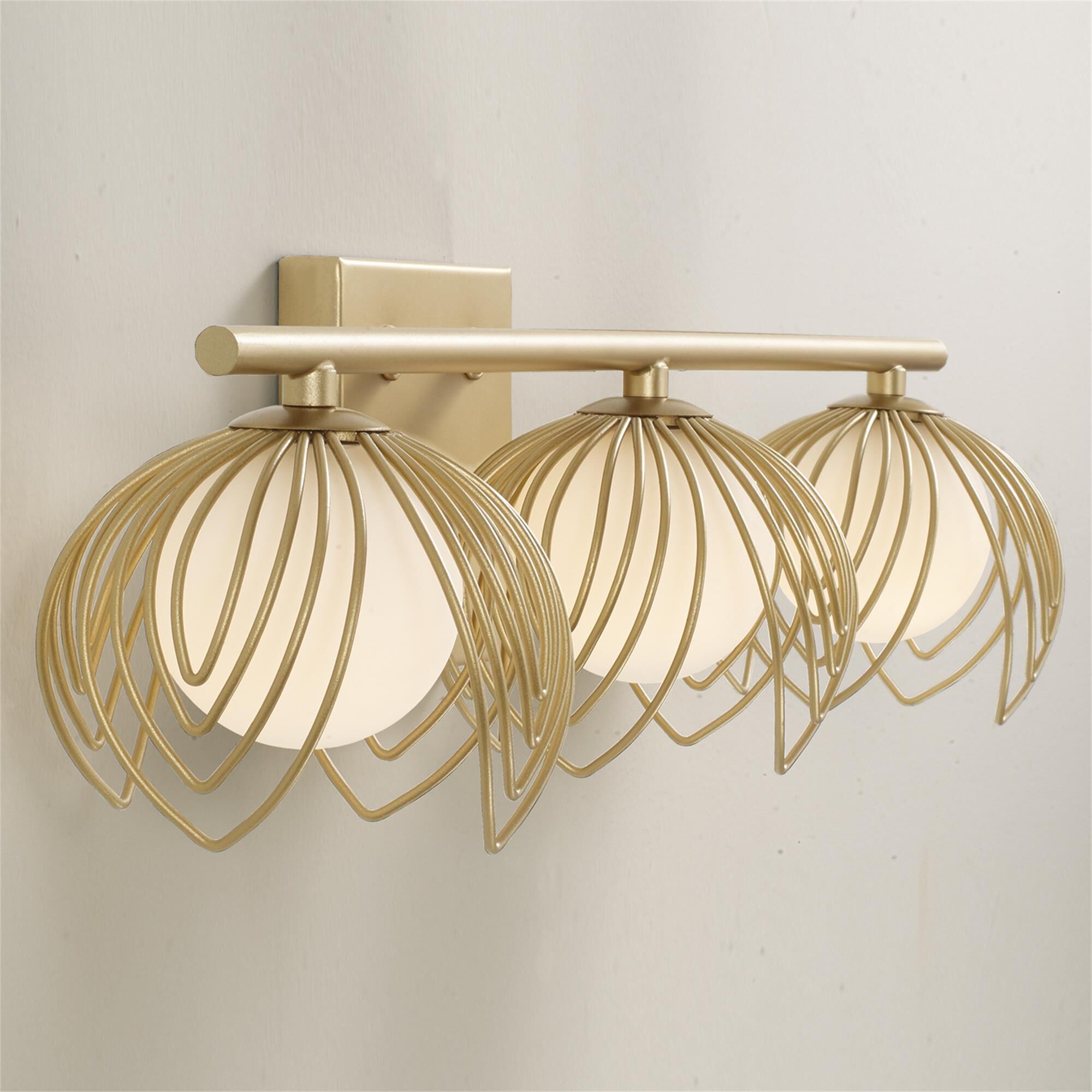 Shown in Buffed Gold finish and Soft White  Globes glass