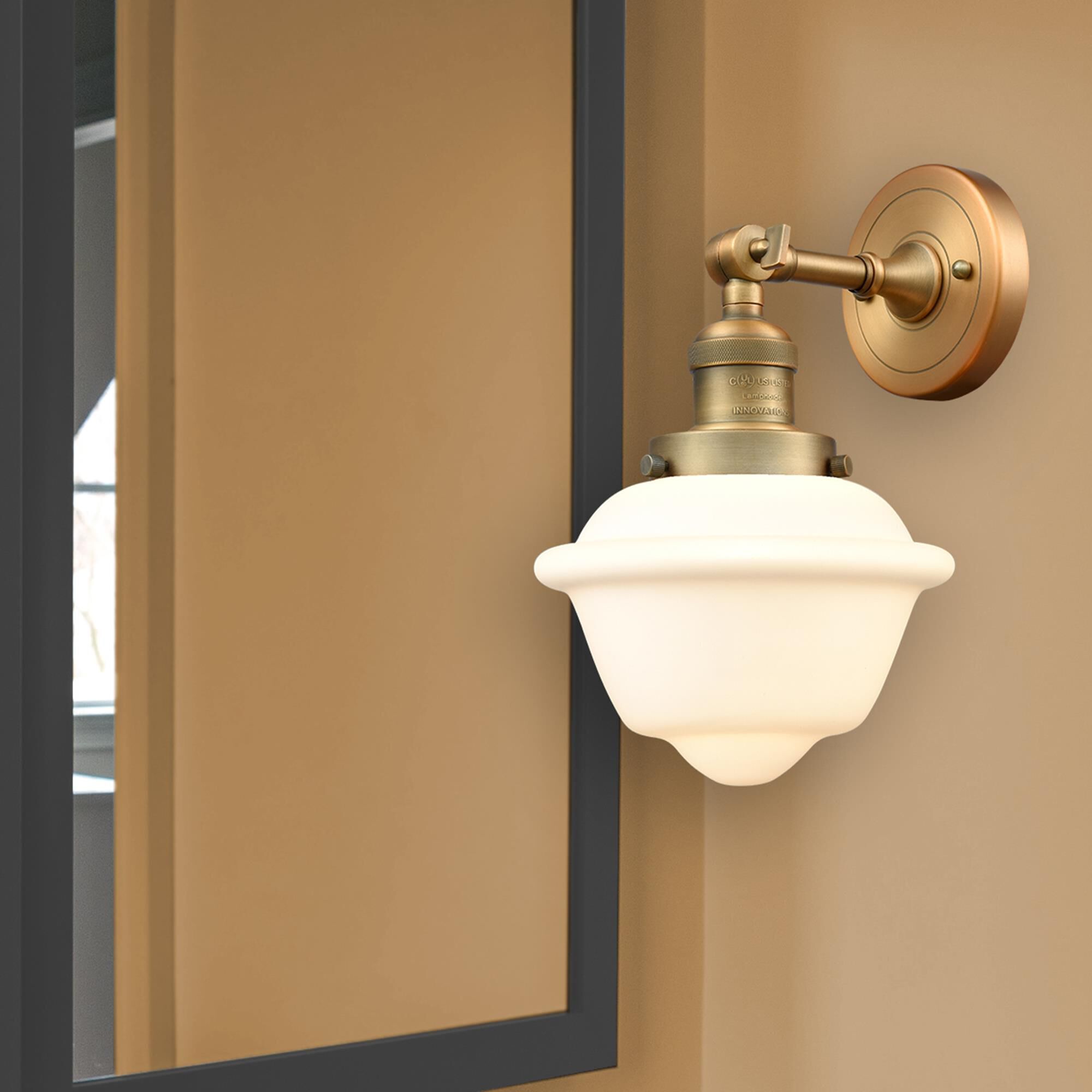 Shown in Brushed Brass finish and Matte White glass