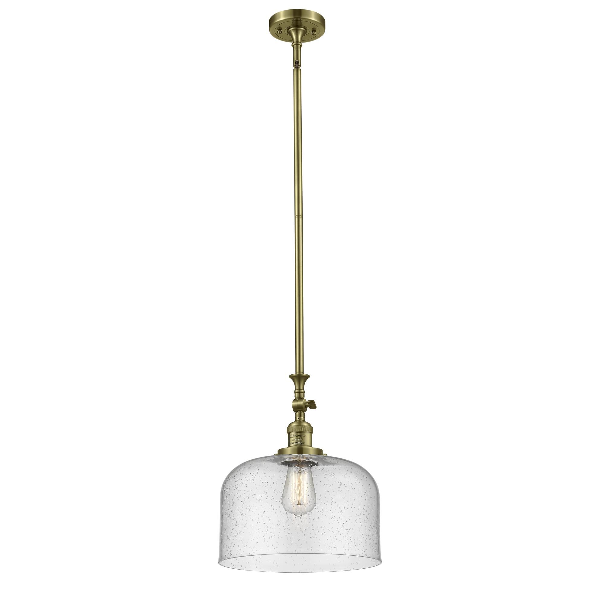 Shown in Antique Brass finish and Seedy glass