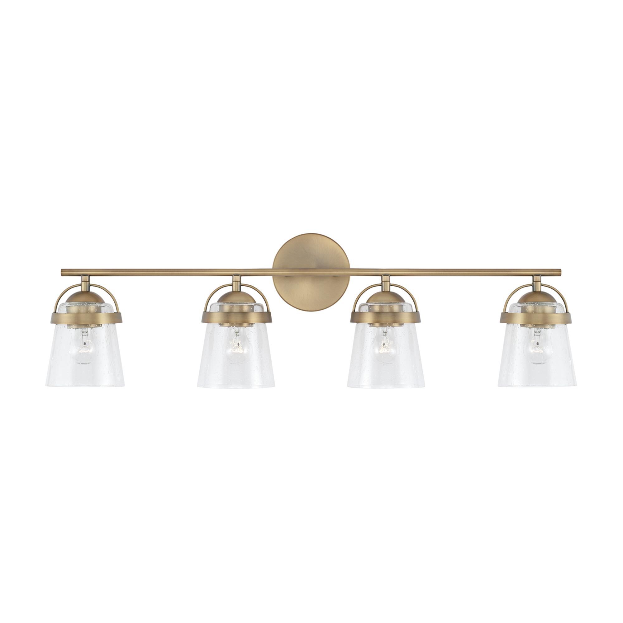 Shown in Aged Brass finish and Clear Seeded glass