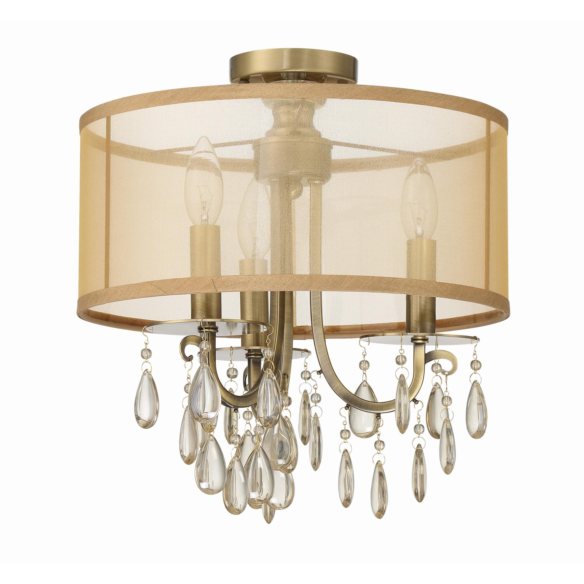 Shown in Antique Brass finish and Etruscan Teardrop Almond crystal and Silk glass and Translucent Gold shade