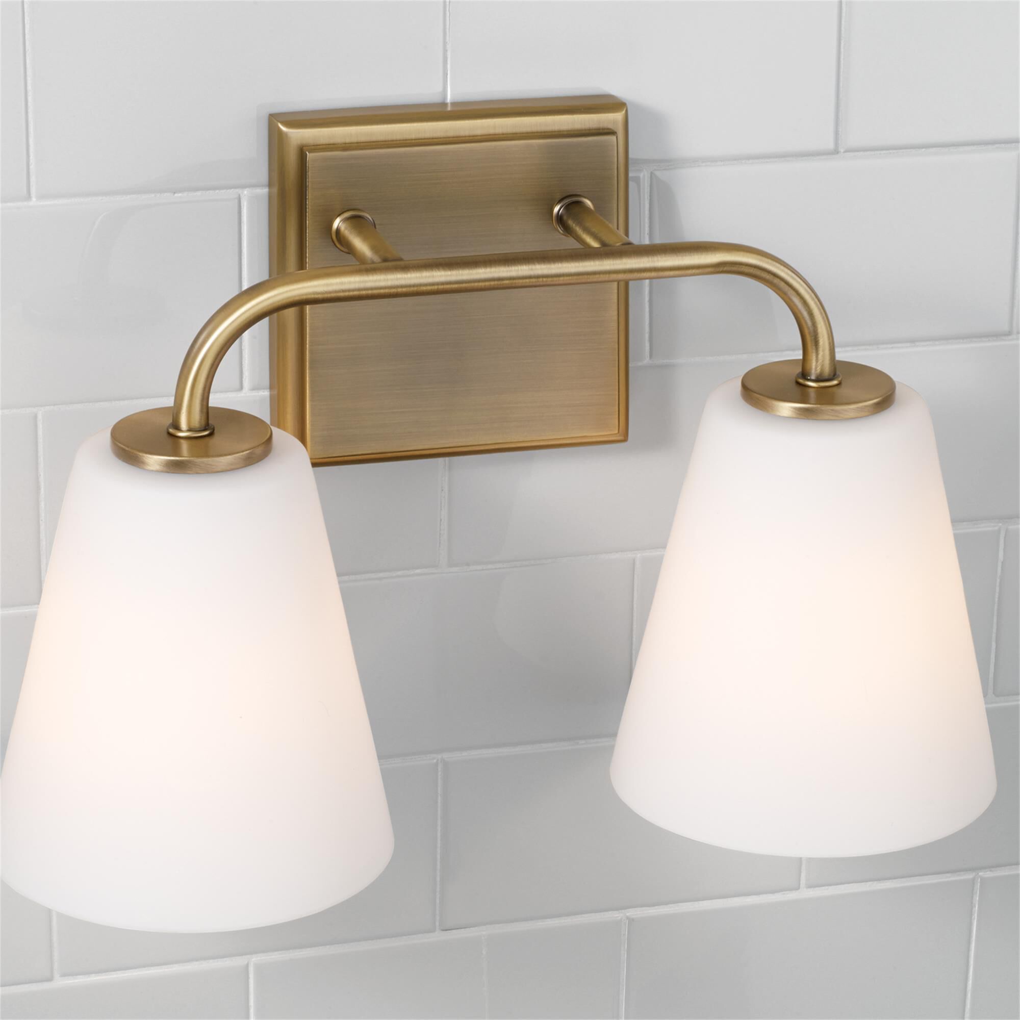Shown in Aged Brass finish and Soft White glass