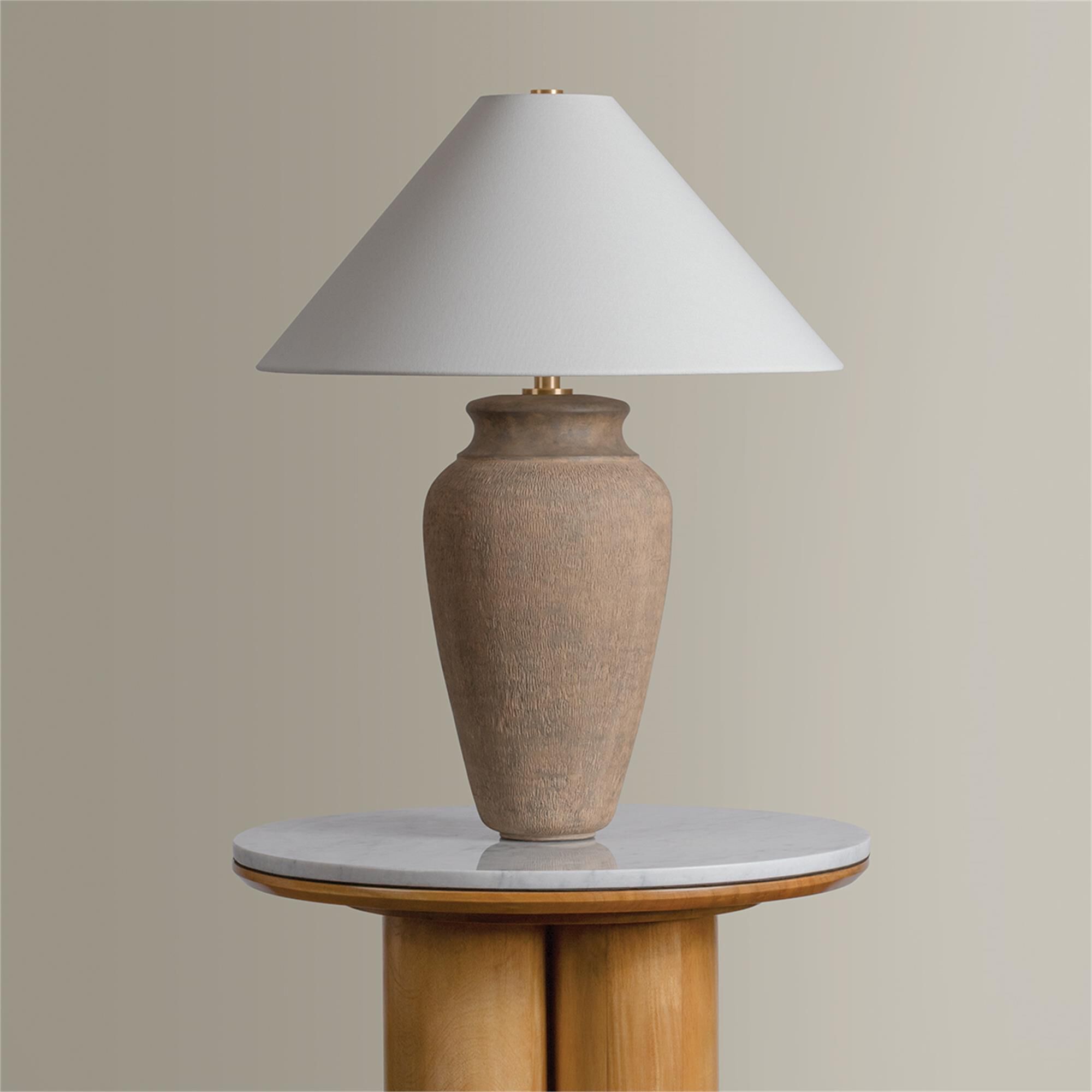Shown in Patina Brass and Ceramic Textural Umber finish and Off White Linen shade