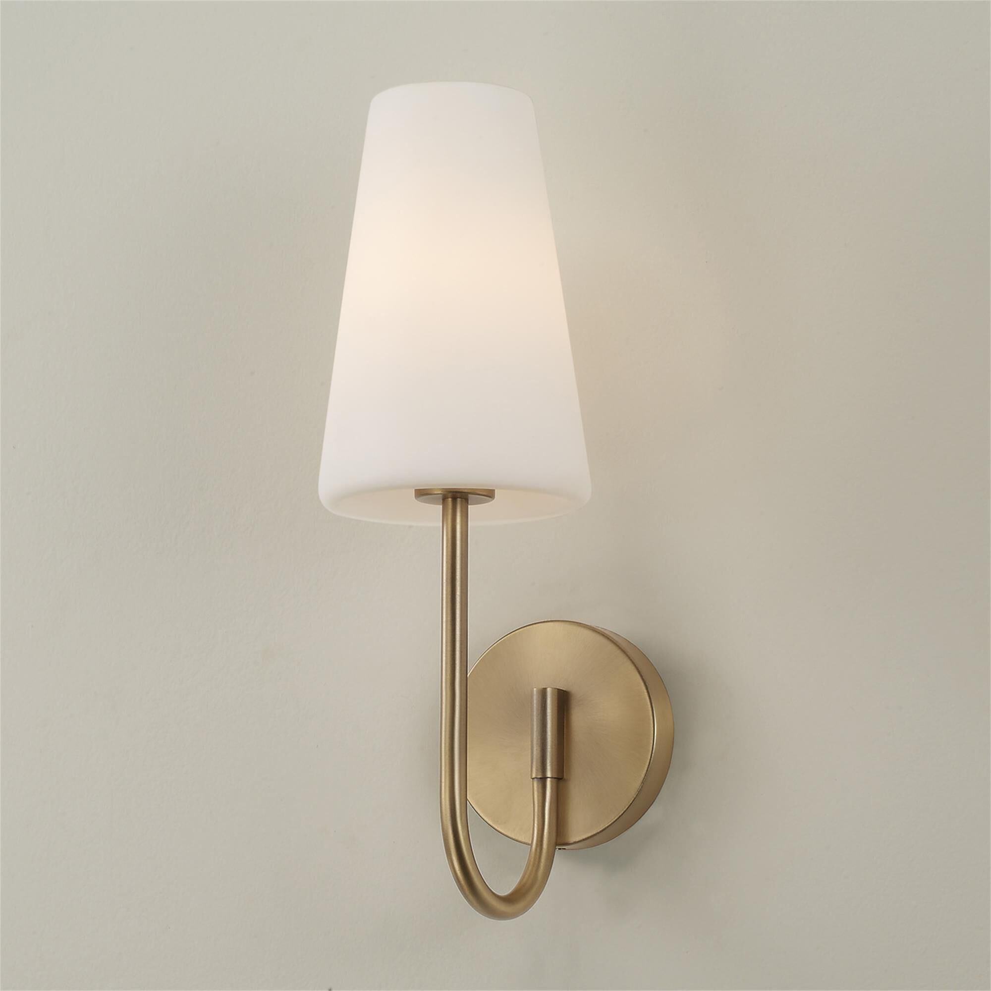 Shown in Aged Brass finish and Soft White glass