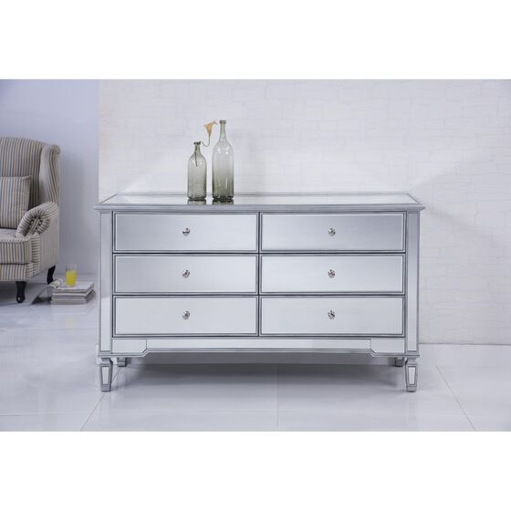 Silver storage cabinet in a room setting with decorative bottles.