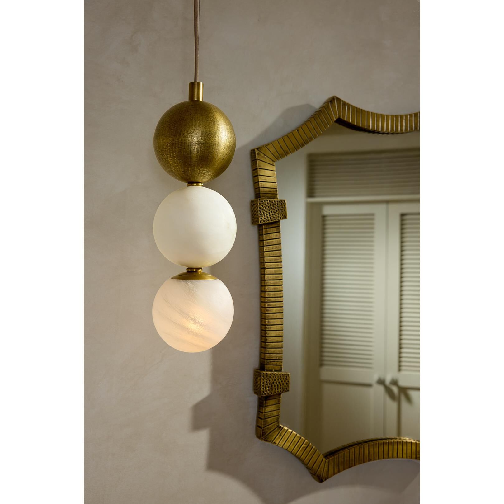 Shown in Antique Brass finish and Matte Swirl glass