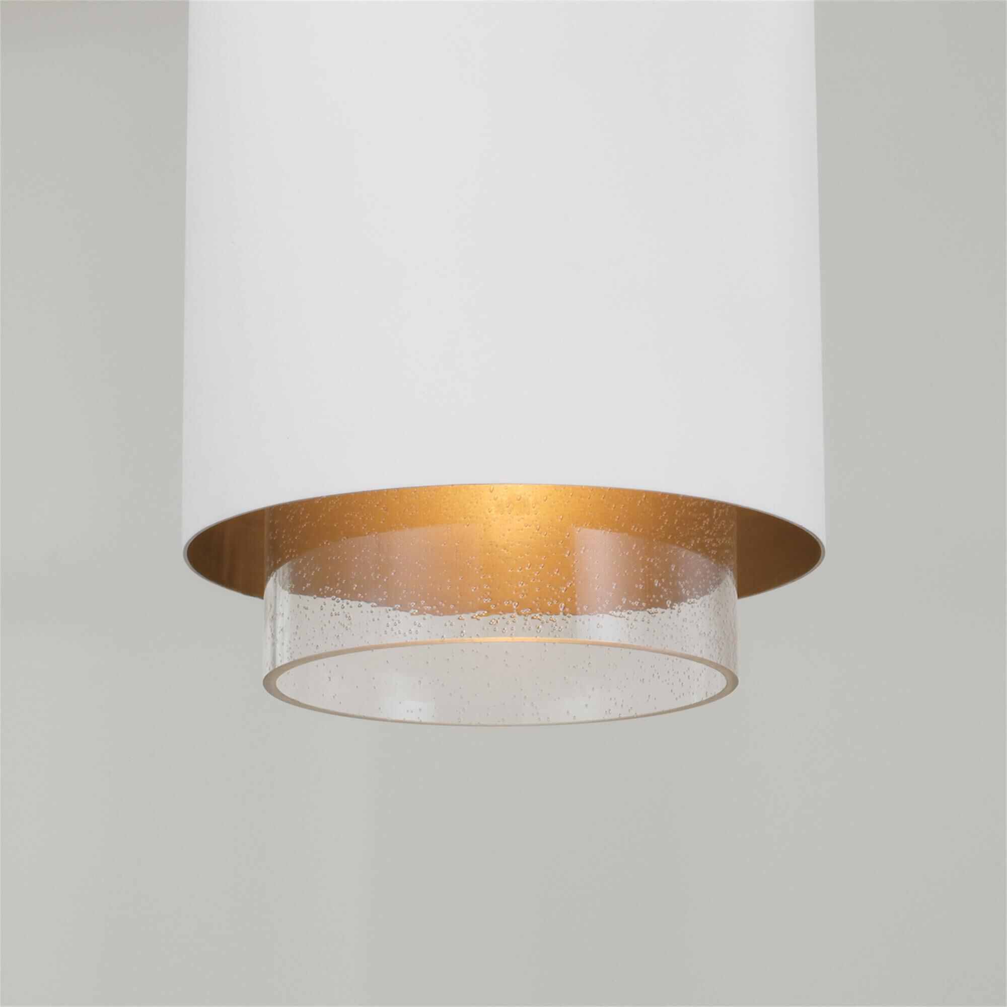 Shown in Matte Brass and White finish and Clear Seeded glass and Metal with Brass Interior shade
