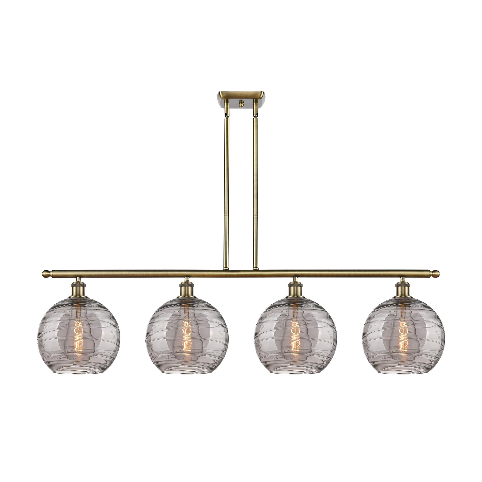Shown in Antique Brass finish and Light Smoke Deco Swirl glass