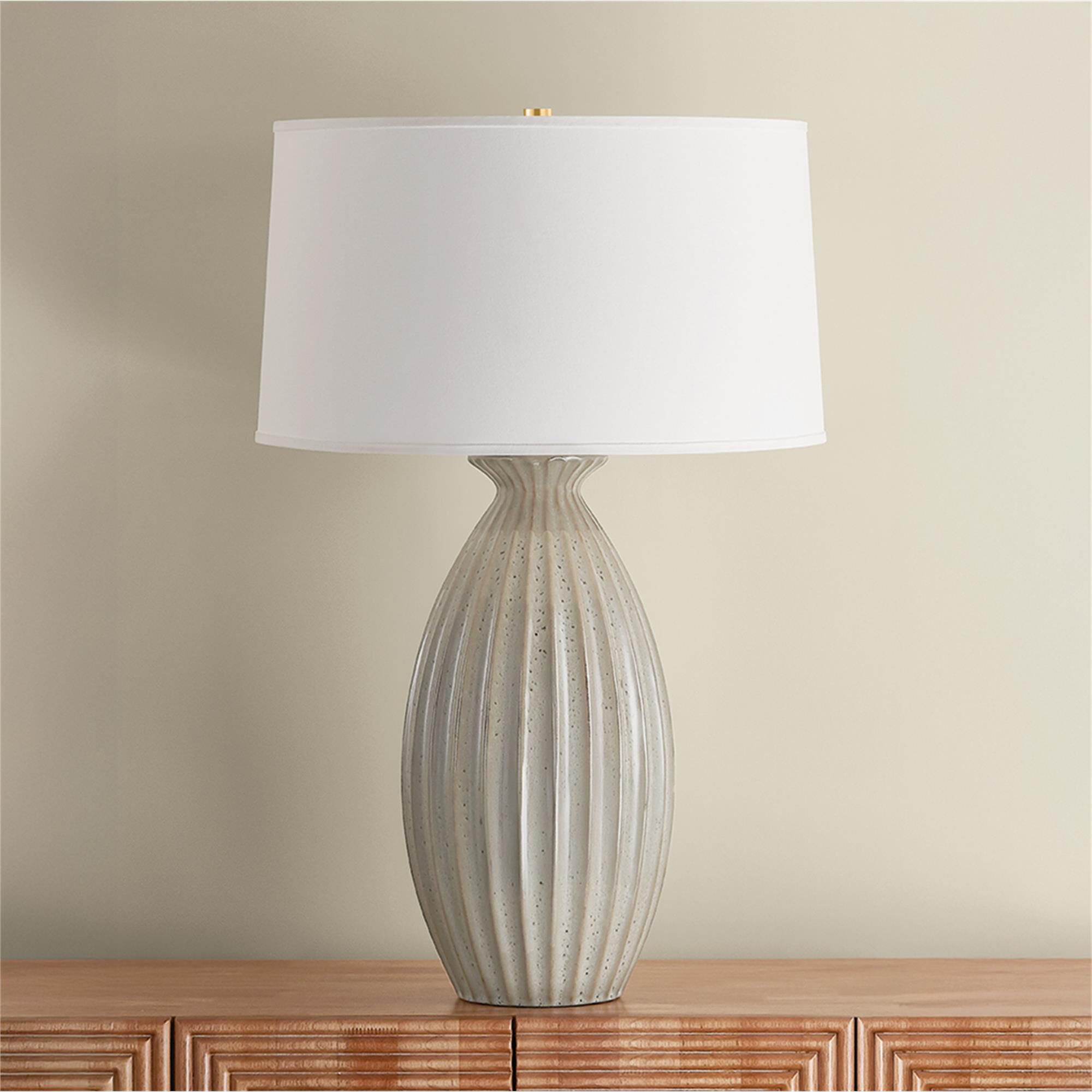Shown in Aged Brass and Ceramic Taupe Velvet finish and White Linen shade