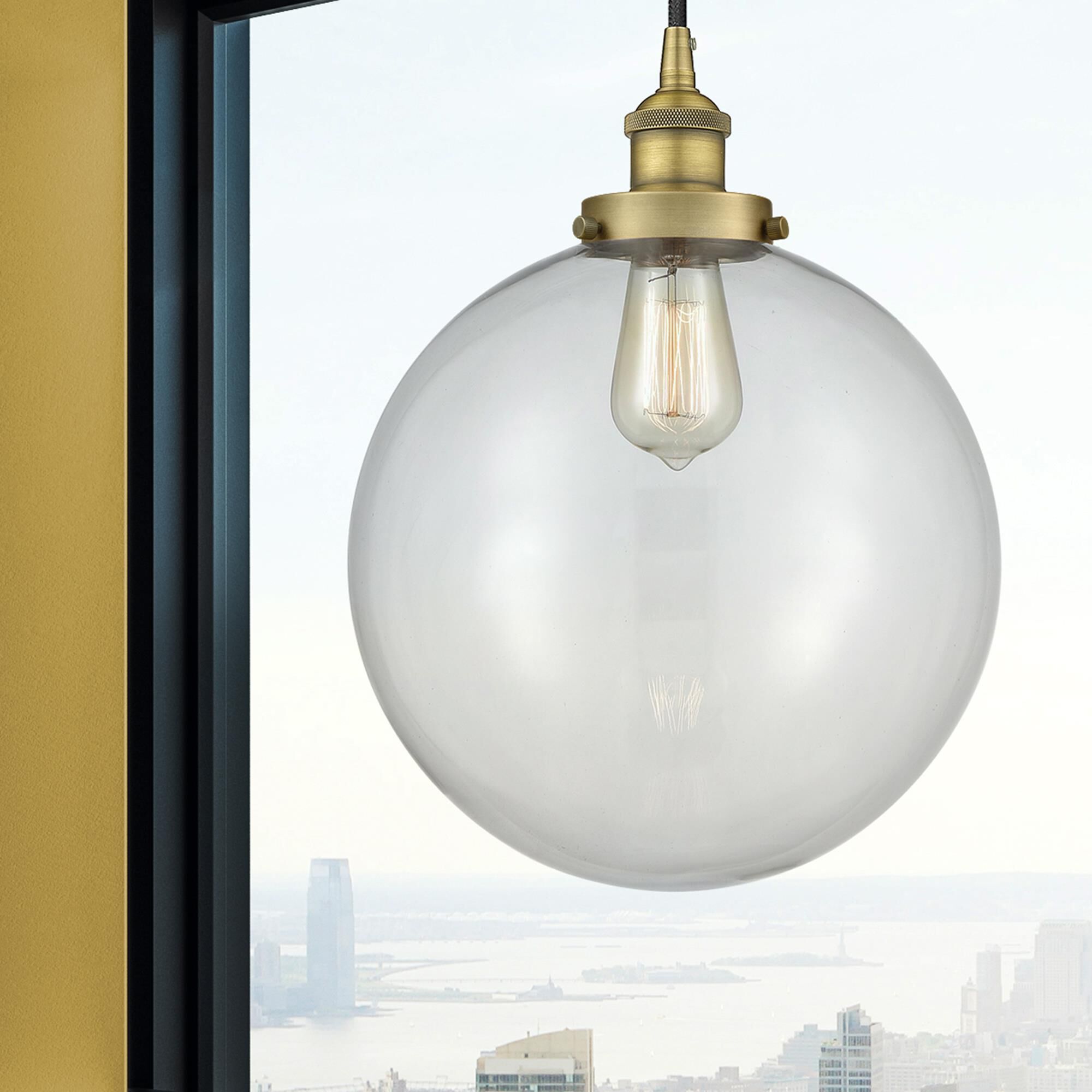 Shown in Brushed Brass finish and Clear Beacon glass