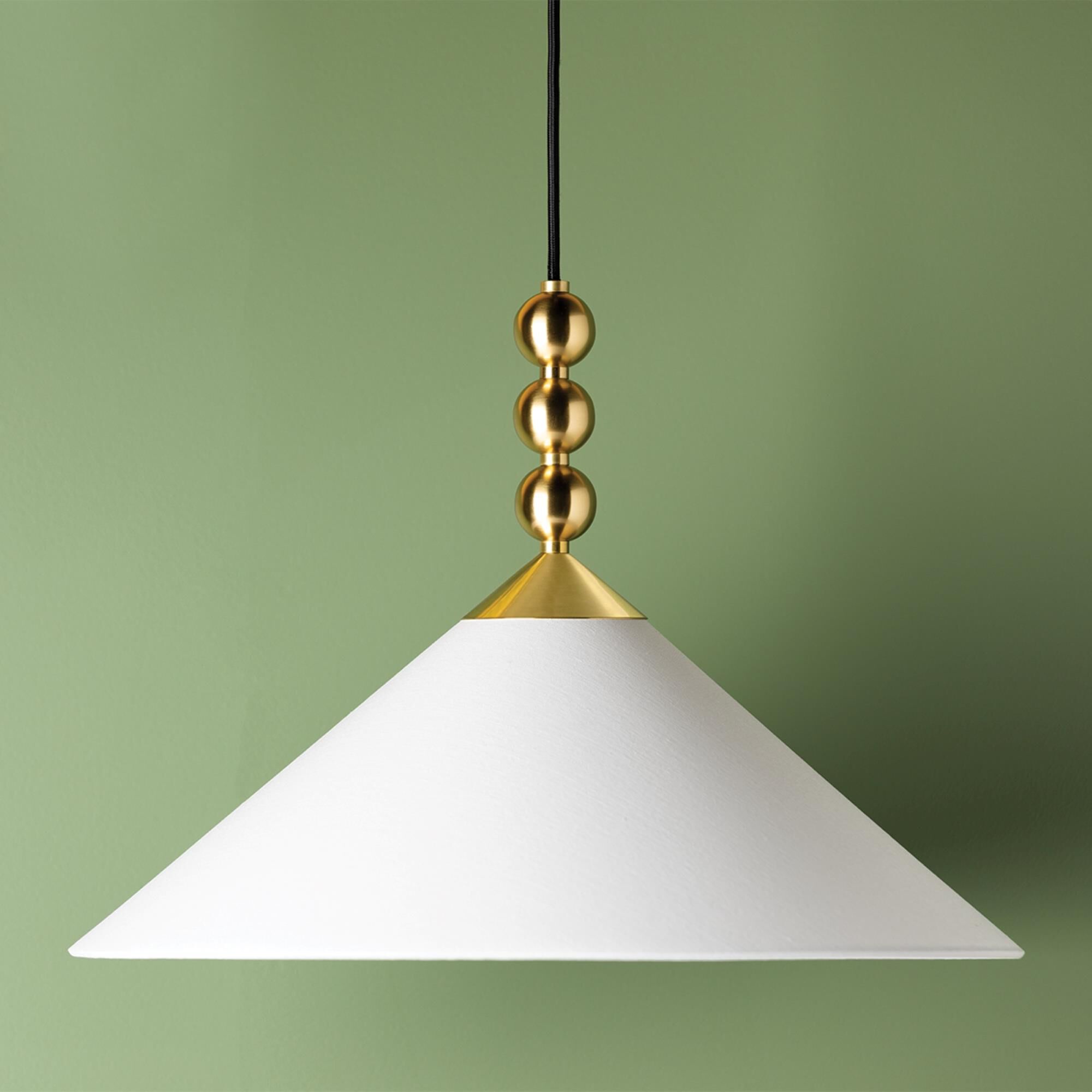 Shown in Aged Brass finish and White Linen shade