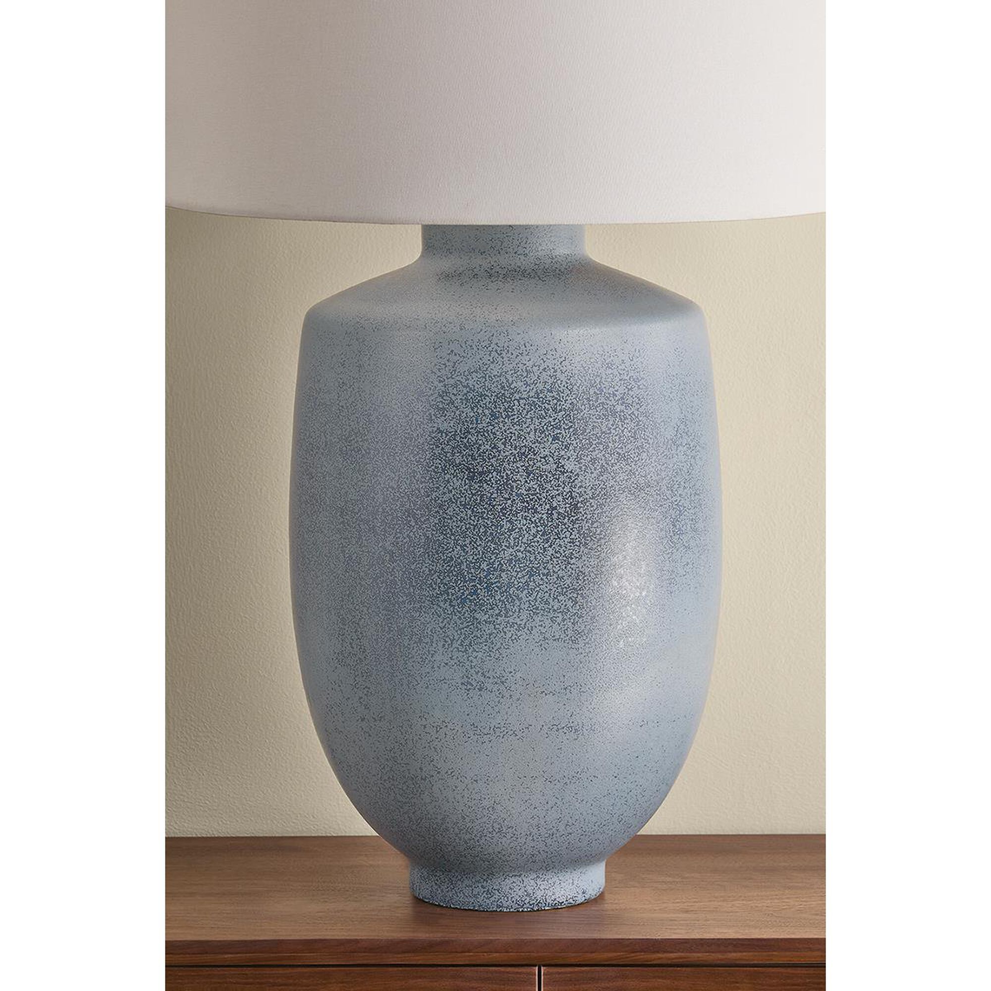 Shown in Aged Brass and Ceramic Oceanside finish and White Linen shade