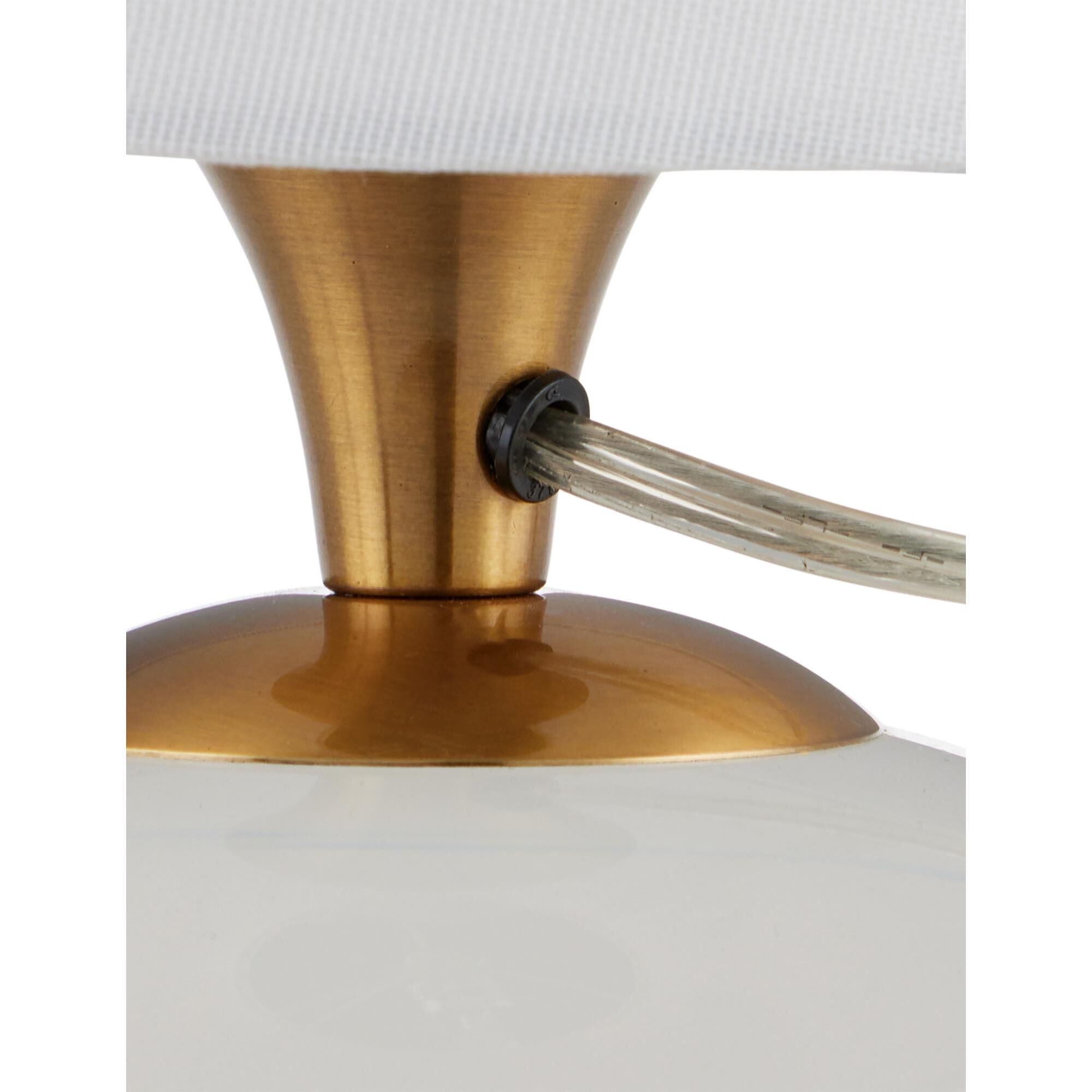 Shown in Clear, Antique Brass finish and White Linen shade