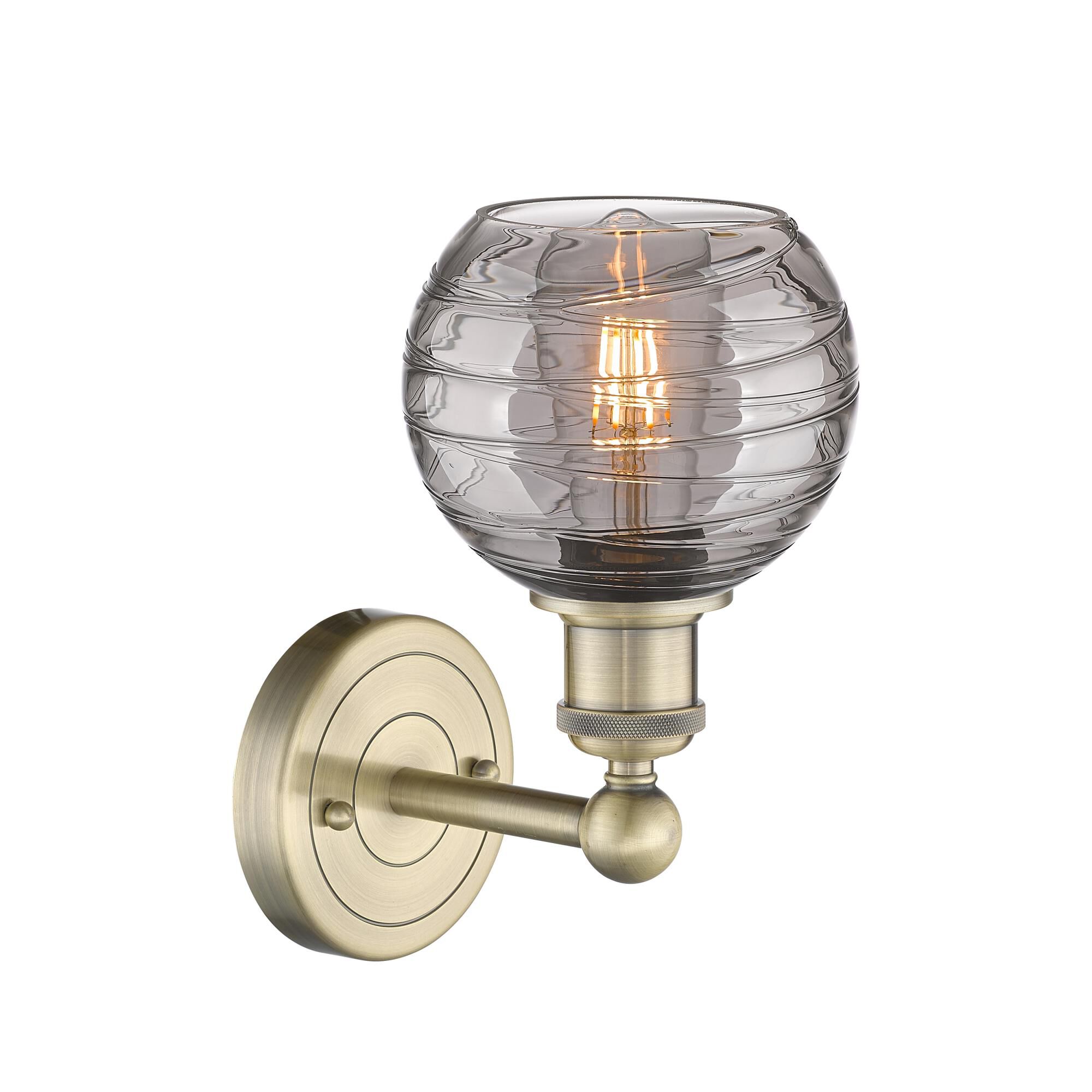 Shown in Antique Brass finish and Light Smoke Deco Swirl glass