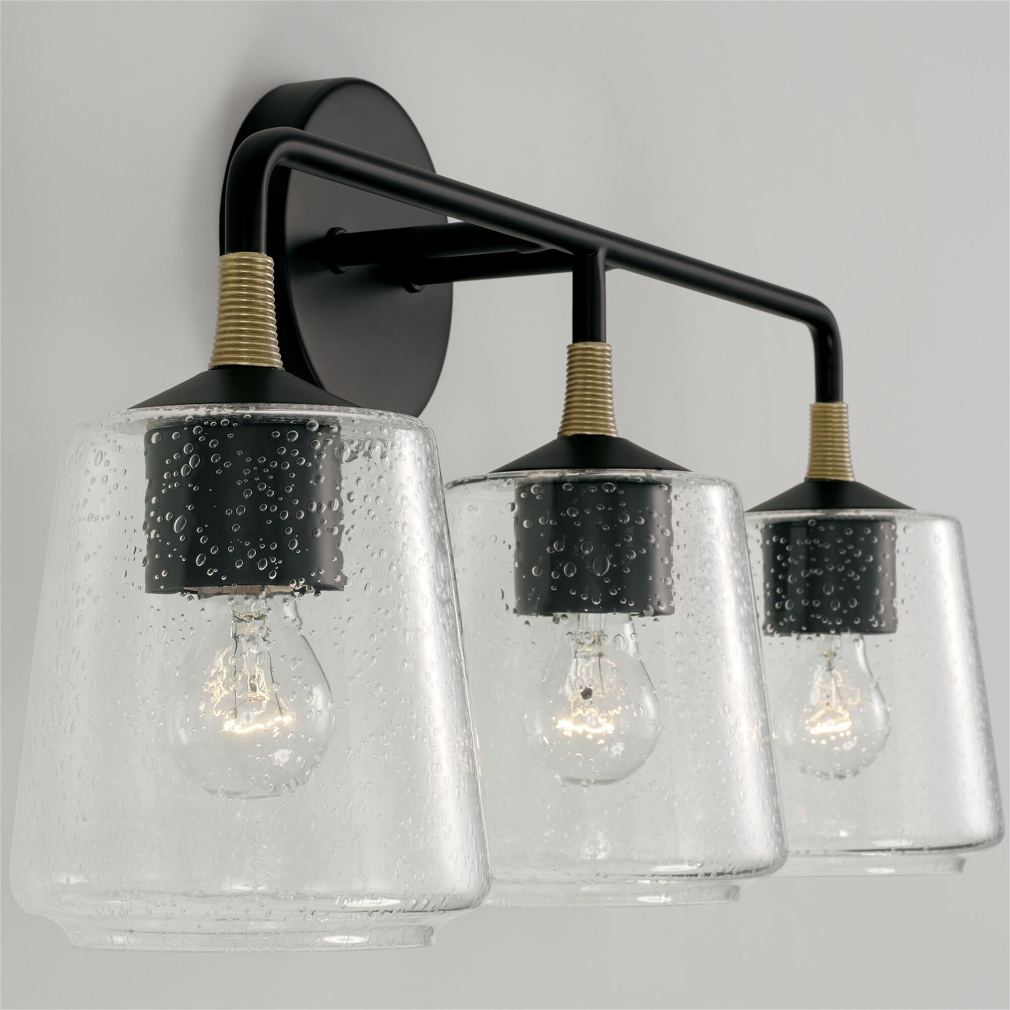 Shown in Matte Black With Brass finish and Clear Seeded glass