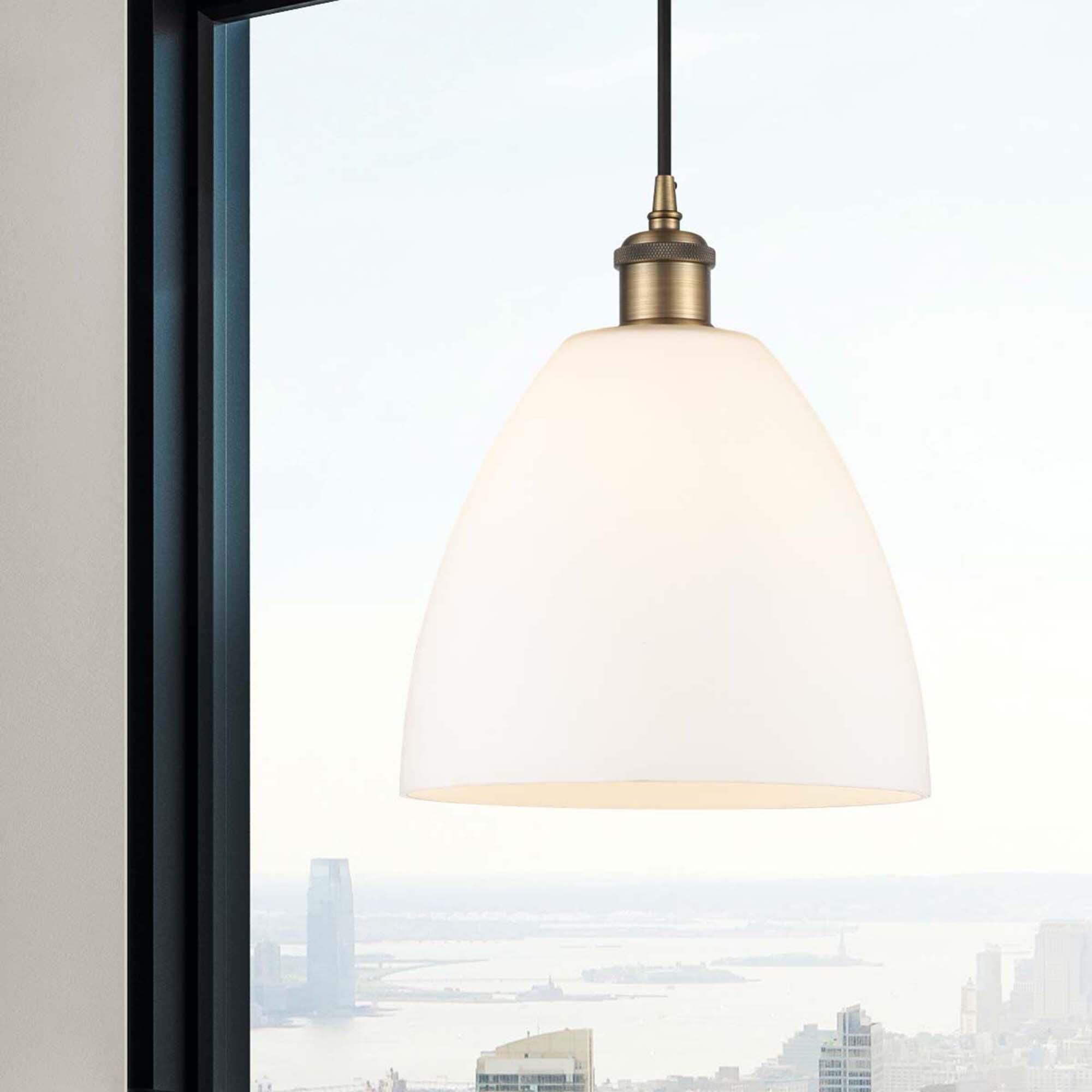 Shown in Brushed Brass finish and Matte White glass