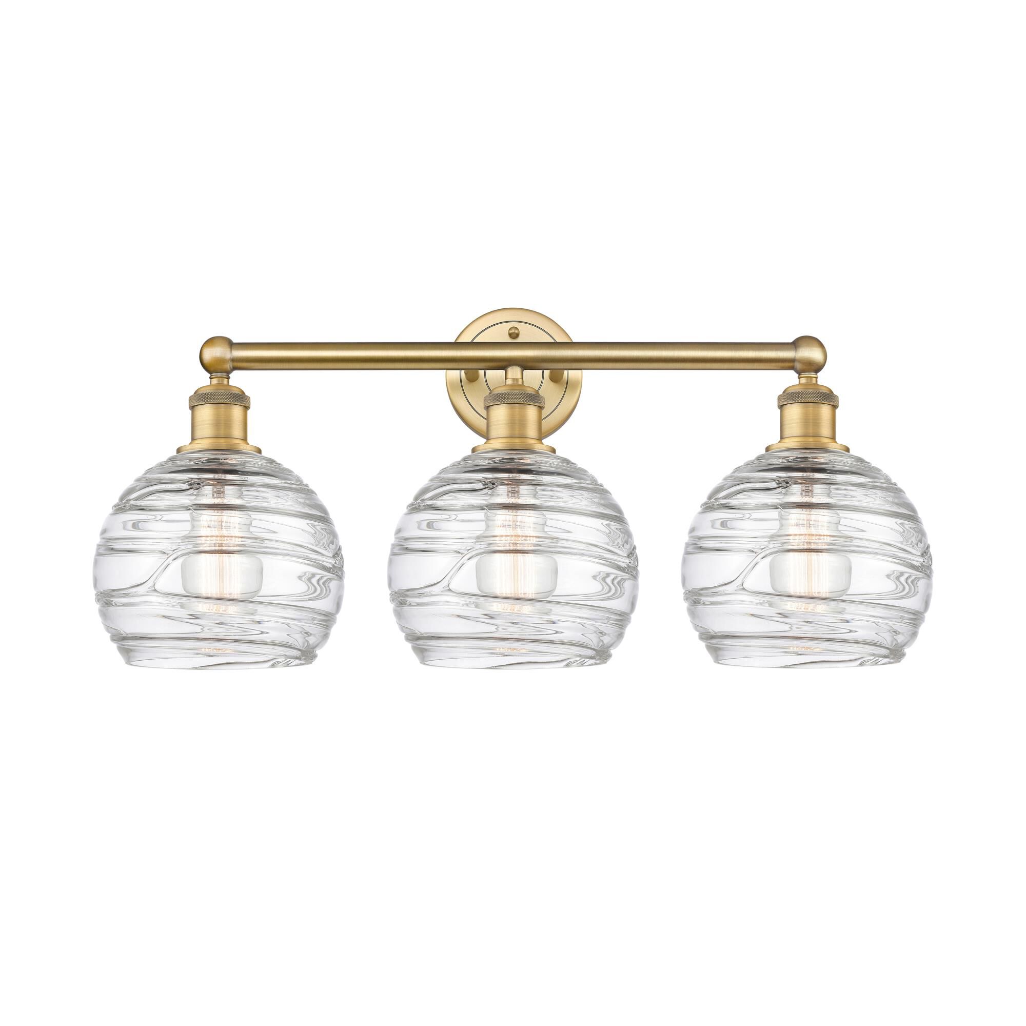 Shown in Brushed Brass finish and Clear Deco Swirl glass