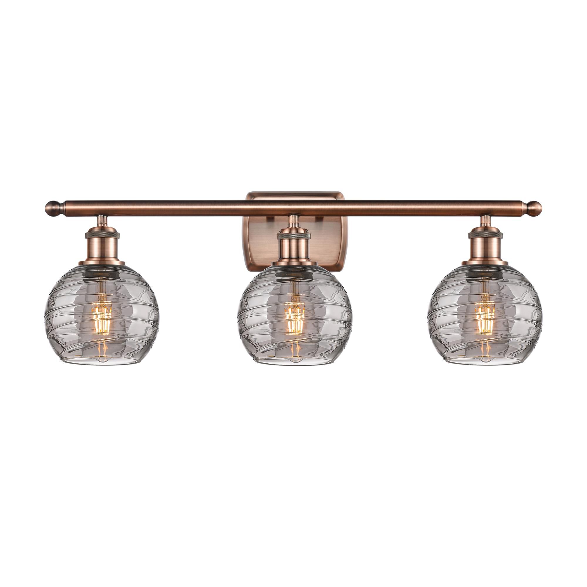Shown in Antique Copper finish and Light Smoke Deco Swirl glass