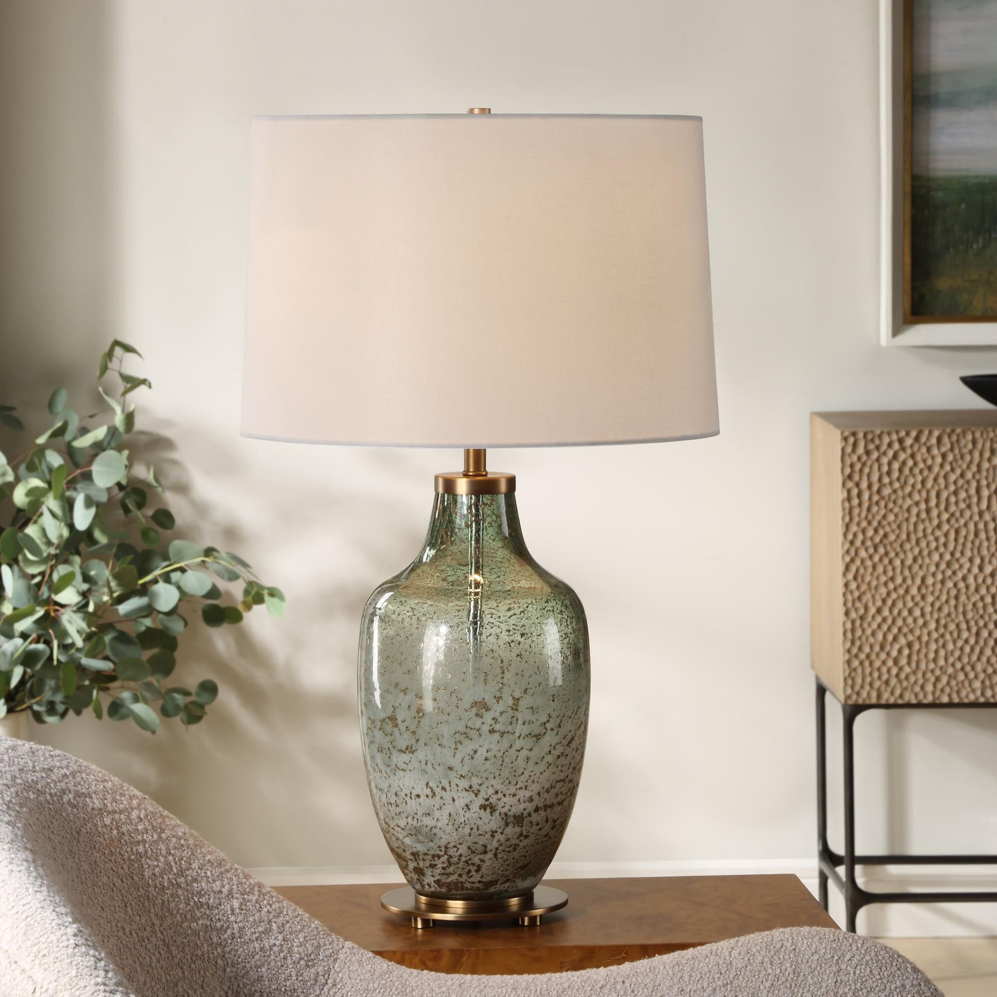 Shown in This Glass Table Lamp Features A Beautiful Blend Of Translucent Olive Green With A Subtle Ivory Wash finish and Round Hardback shade