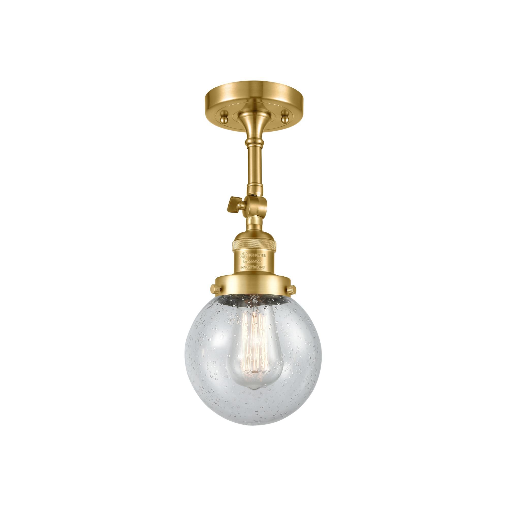 Shown in Satin Gold finish and Seedy glass and None accent
