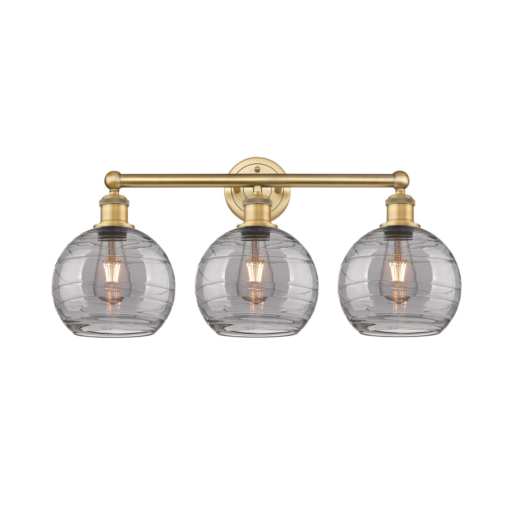 Shown in Brushed Brass finish and Light Smoke Deco Swirl glass