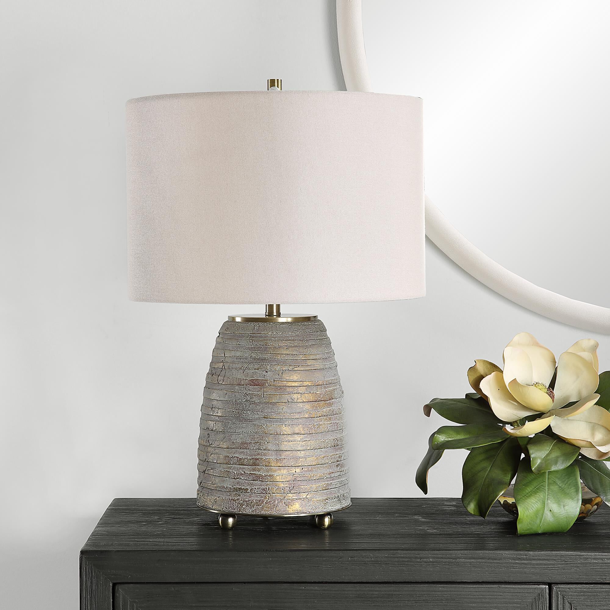 Shown in Rustic Meets Sophisticated With The Gorda Lamp. Featuring Heavily Textured Bronze Ceramic With A Gre finish and Round Drum Hardback shade