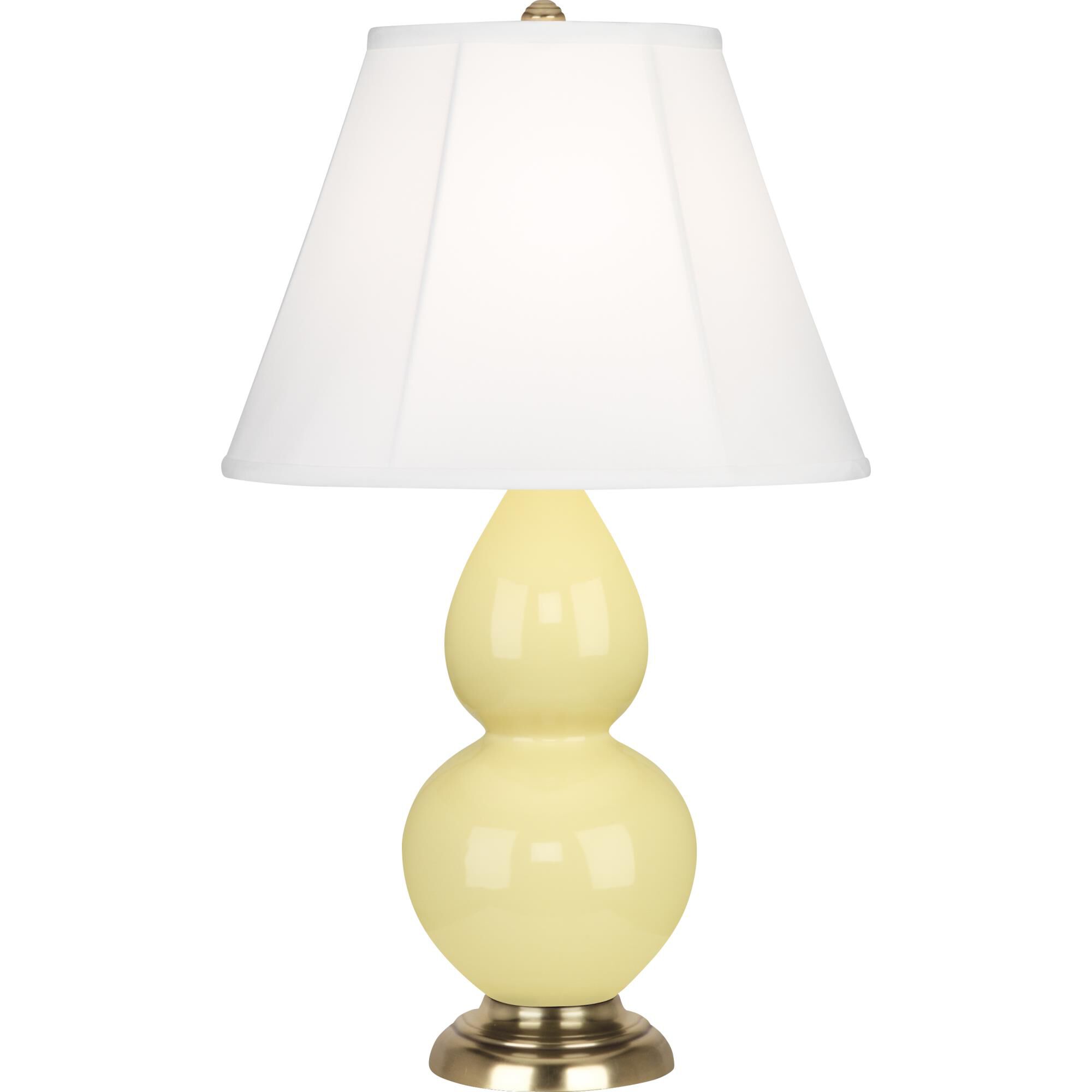 Shown in Butter Glazed Ceramic With Antique Natural Brass ed Accents finish and Ivory Silk Stretched Fabric shade