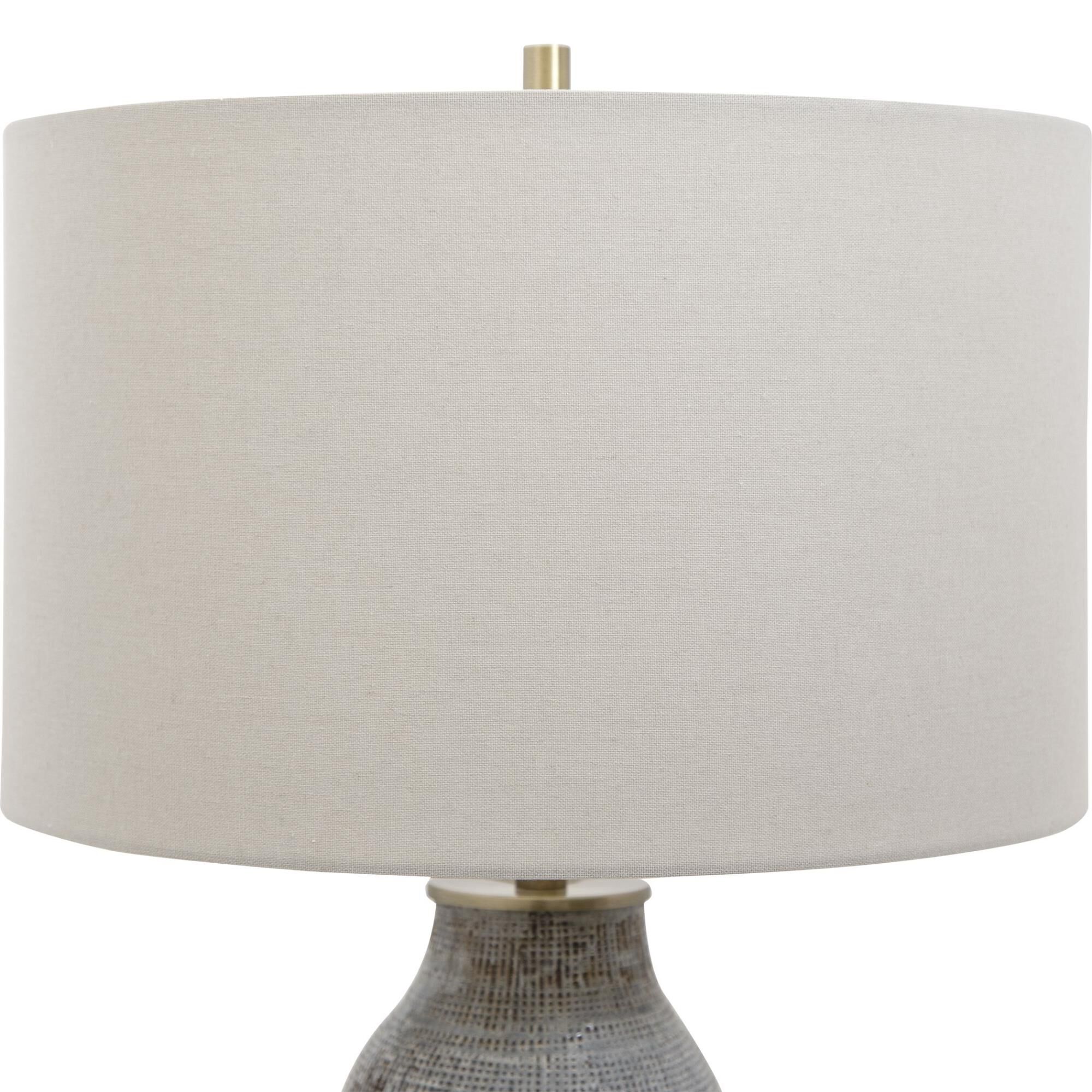 Shown in Exhibiting A Handcrafted Look, This Ceramic Table Lamp Features A Textured Finish Reminiscent Of Wov finish and Round Hardback Drum shade